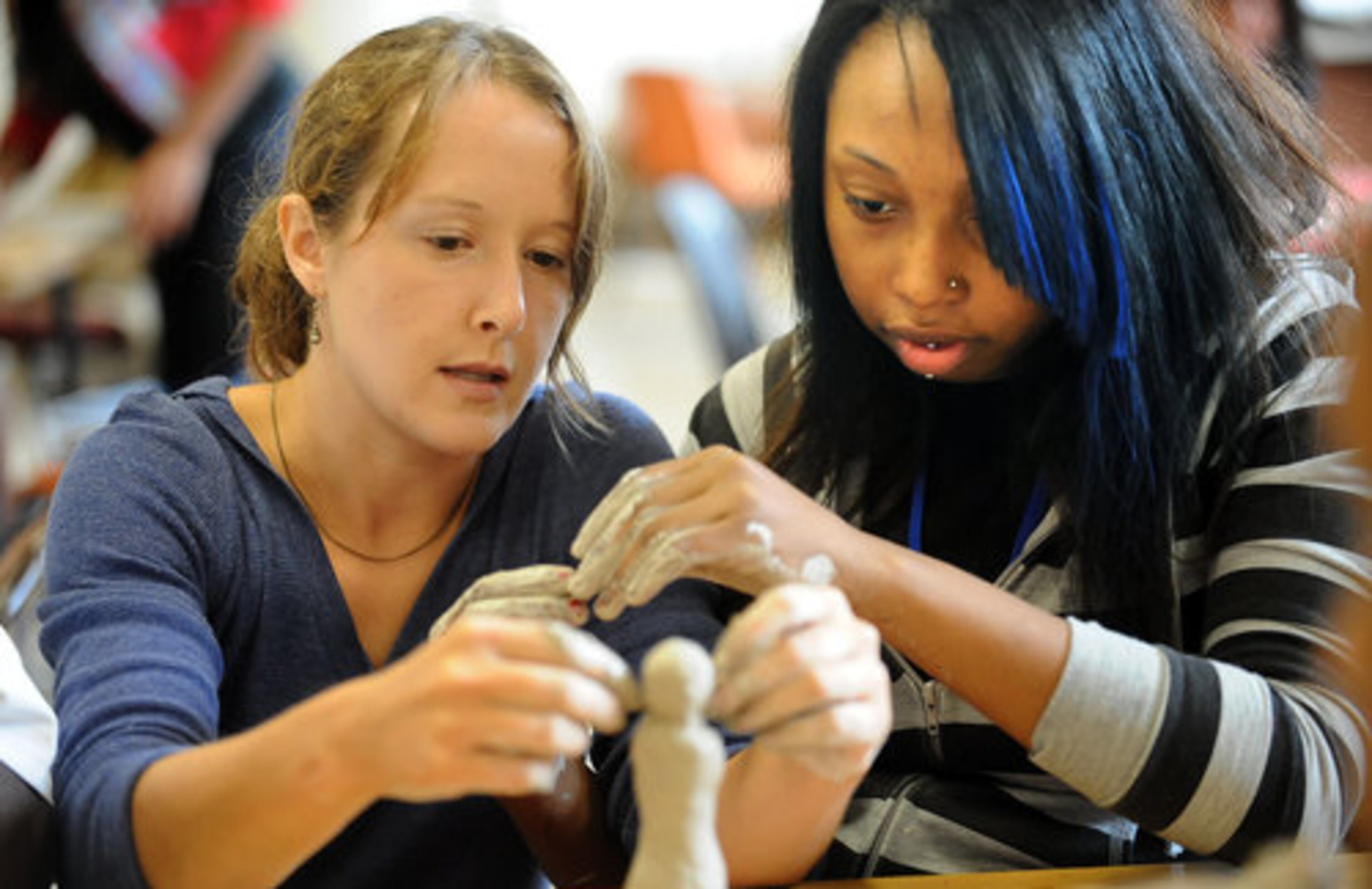 Elaina Tess (left), art teacher, instructs Jermaine Wright, 16, during arts class at Southside. Superintendent Beverly Hall hopes that the personal and challenging experiences will help reverse the system's high percentage of dropouts and low graduation rate.