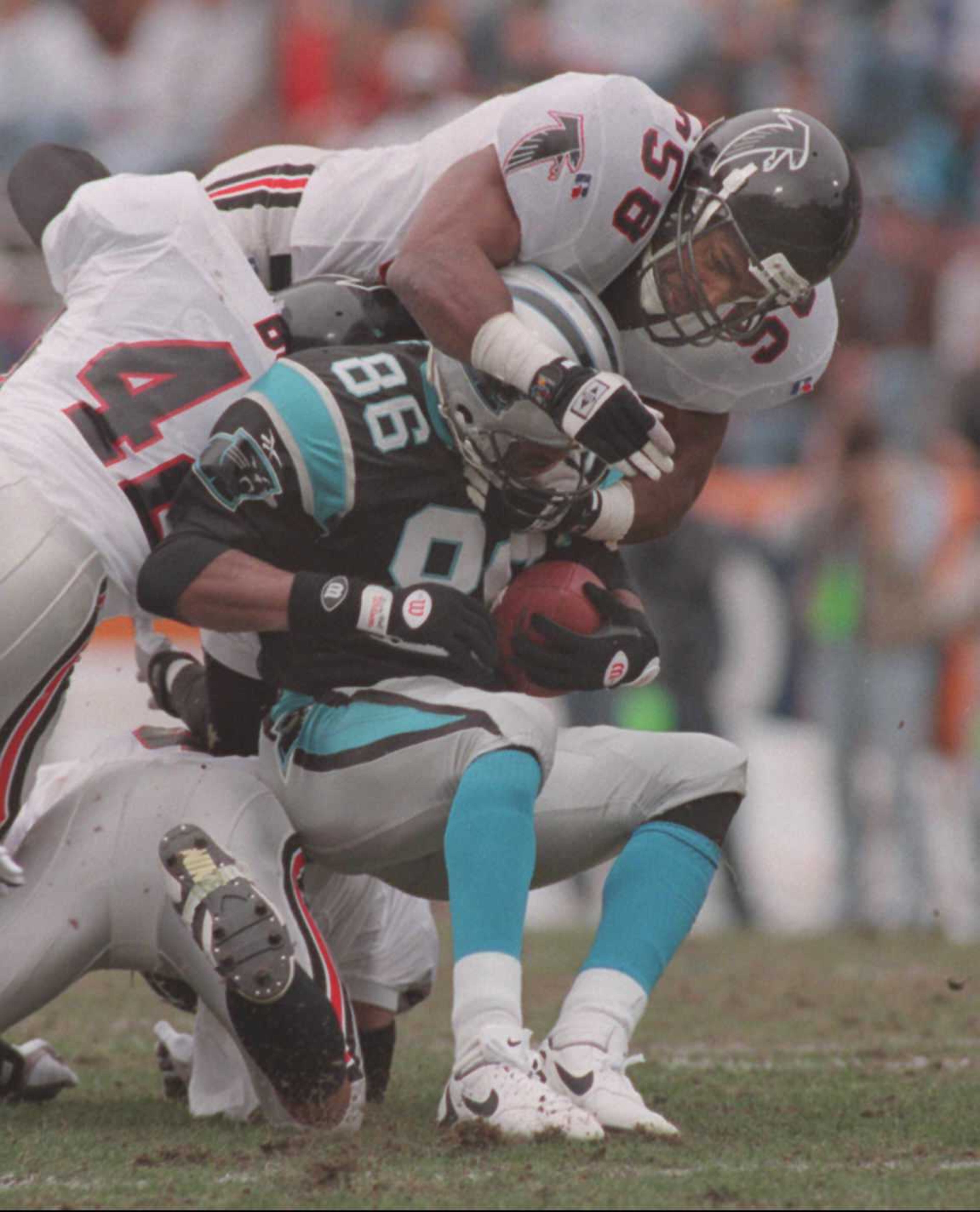 Falcons linebacker Jessie Tuggle (58) hammers Carolina's Willie Green on Dec. 17, 1995. (AJC archives/Marlene Karas)