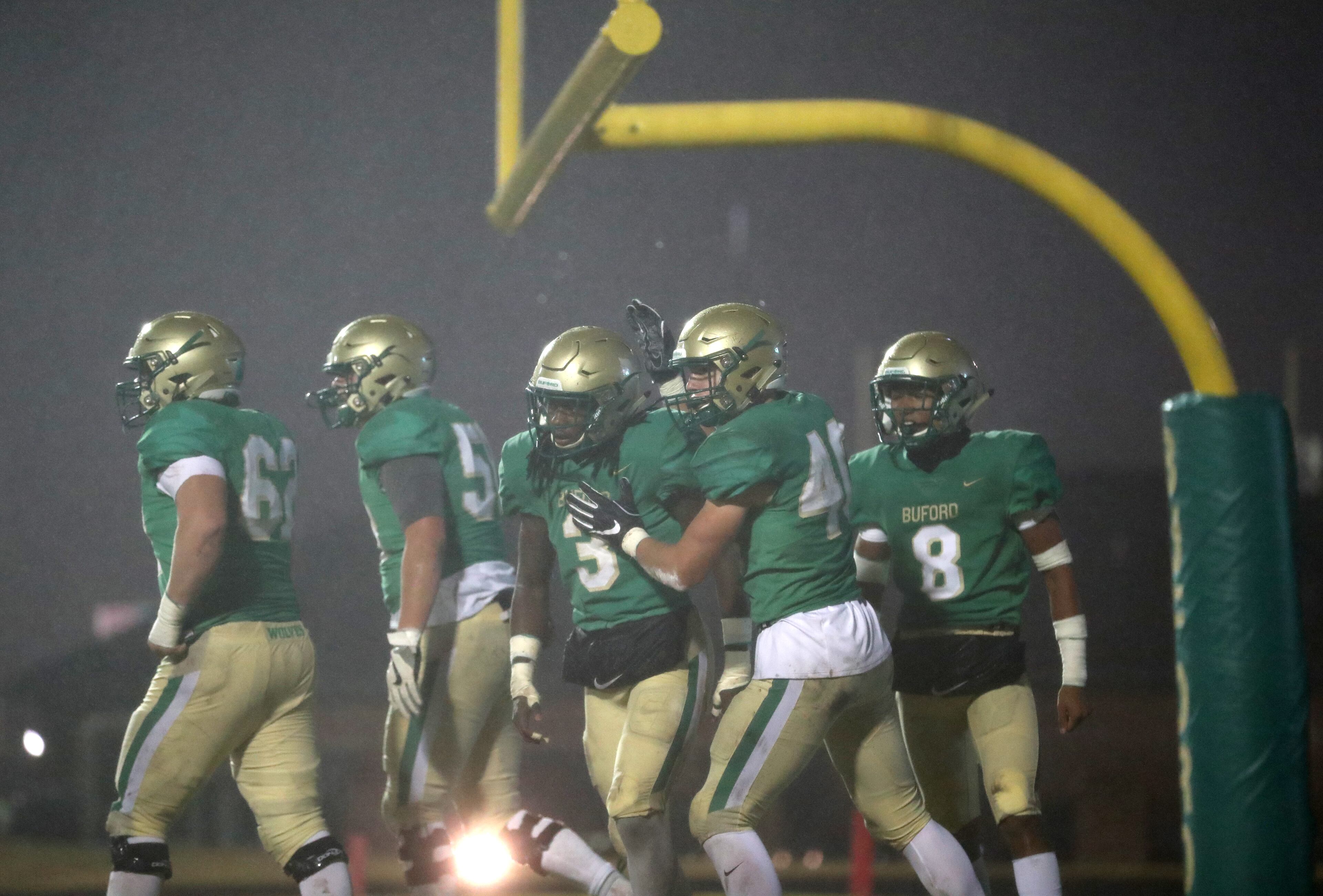 November 23, 2018 - Buford, Ga: Buford running back Derrian Brown (3, center) celebrates a rushing touchdown in the first half against Bainbridge at Buford High School Friday, November 23, 2018, in Buford, Ga. This is the quarter finals of the Class 5A state playoffs. (JASON GETZ/SPECIAL TO THE AJC)