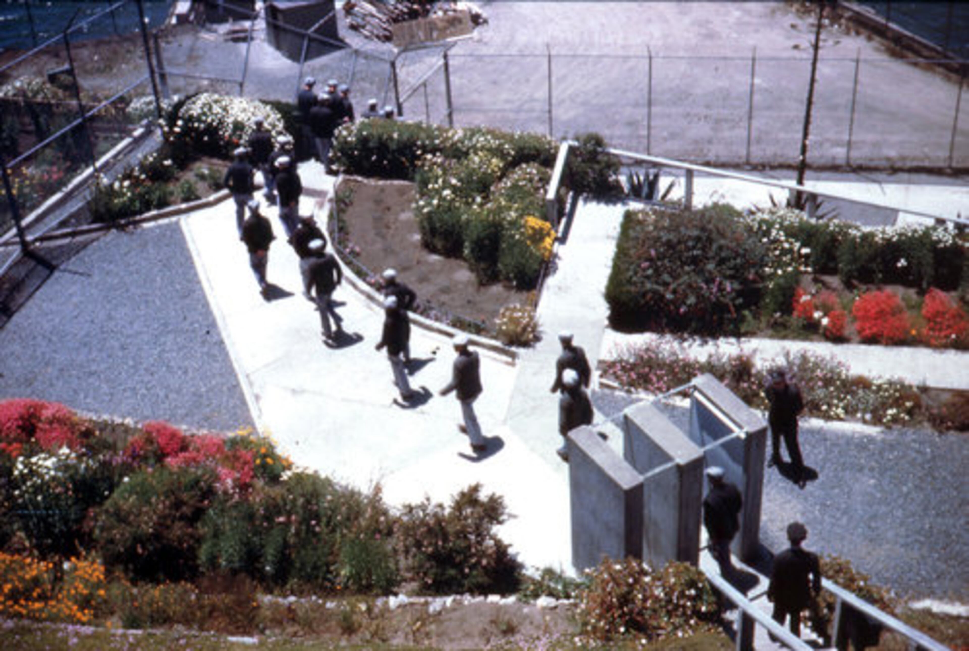 This undated photo released by the Garden Conservancy shows prisoners crossing the Greenhouse Garden on Alcatraz Island in San Francisco.