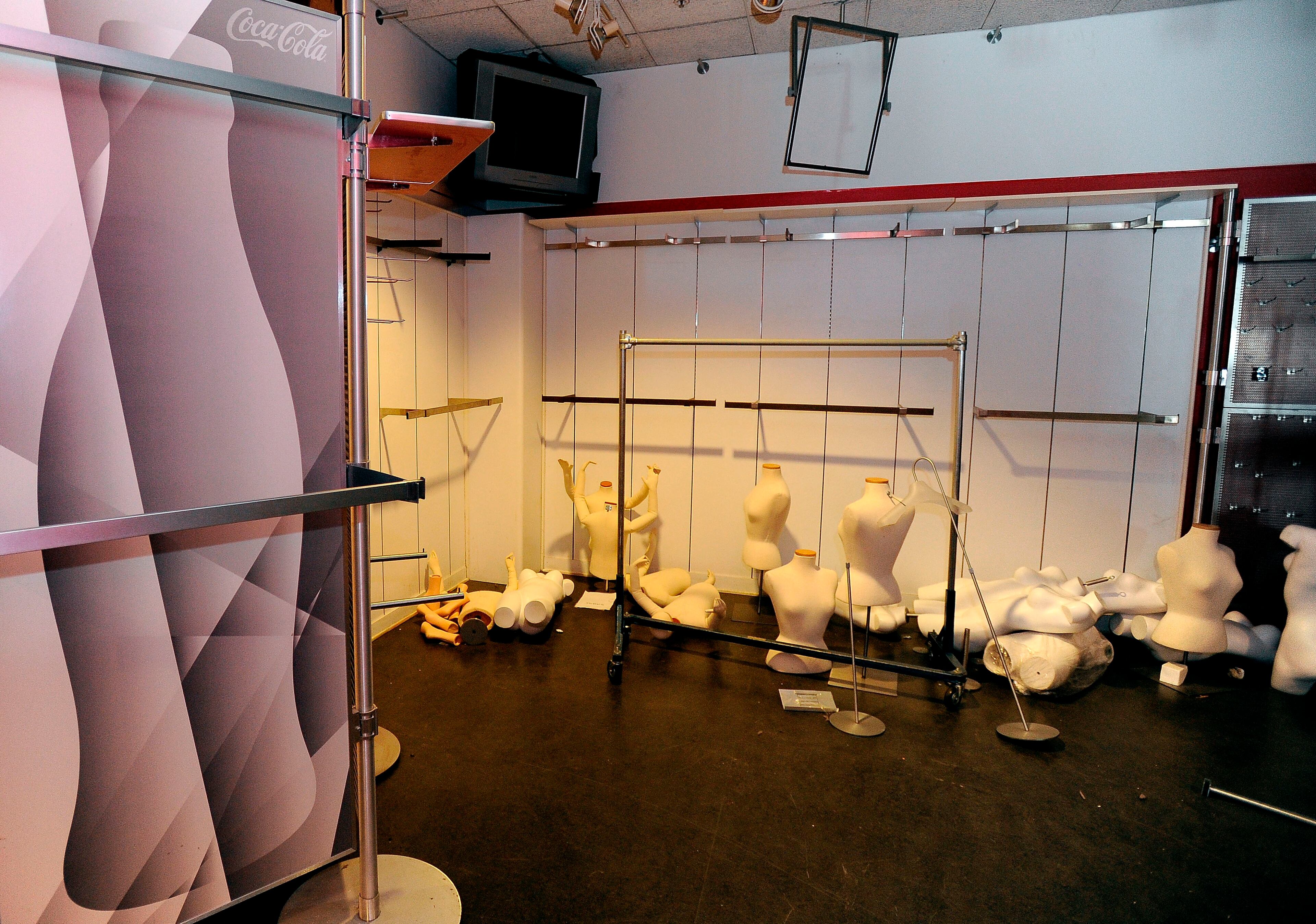 The former World of Coca-Cola building has been vacant since the soft drink company moved its museum to Centennial Park six years ago. Mannequins that formerly displayed gift items remain scattered on the floor next to a poster of the distinctive soft drink bottle Friday, June 28, 2013, in Atlanta. David Tulis / AJC Special