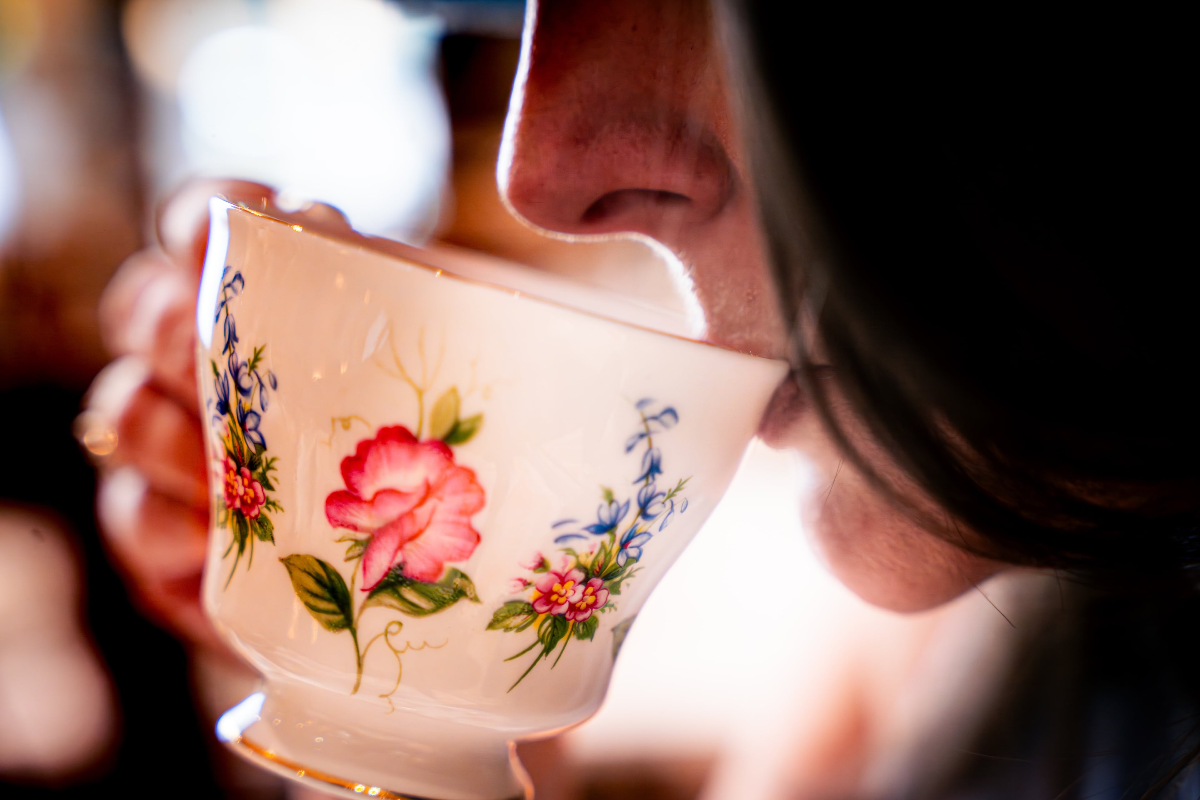 A customer at Le Faucheur takes a sip from the one of the shop’s traditional teacups. (Courtesy of Daniel Fatemi/Le Faucheur)
