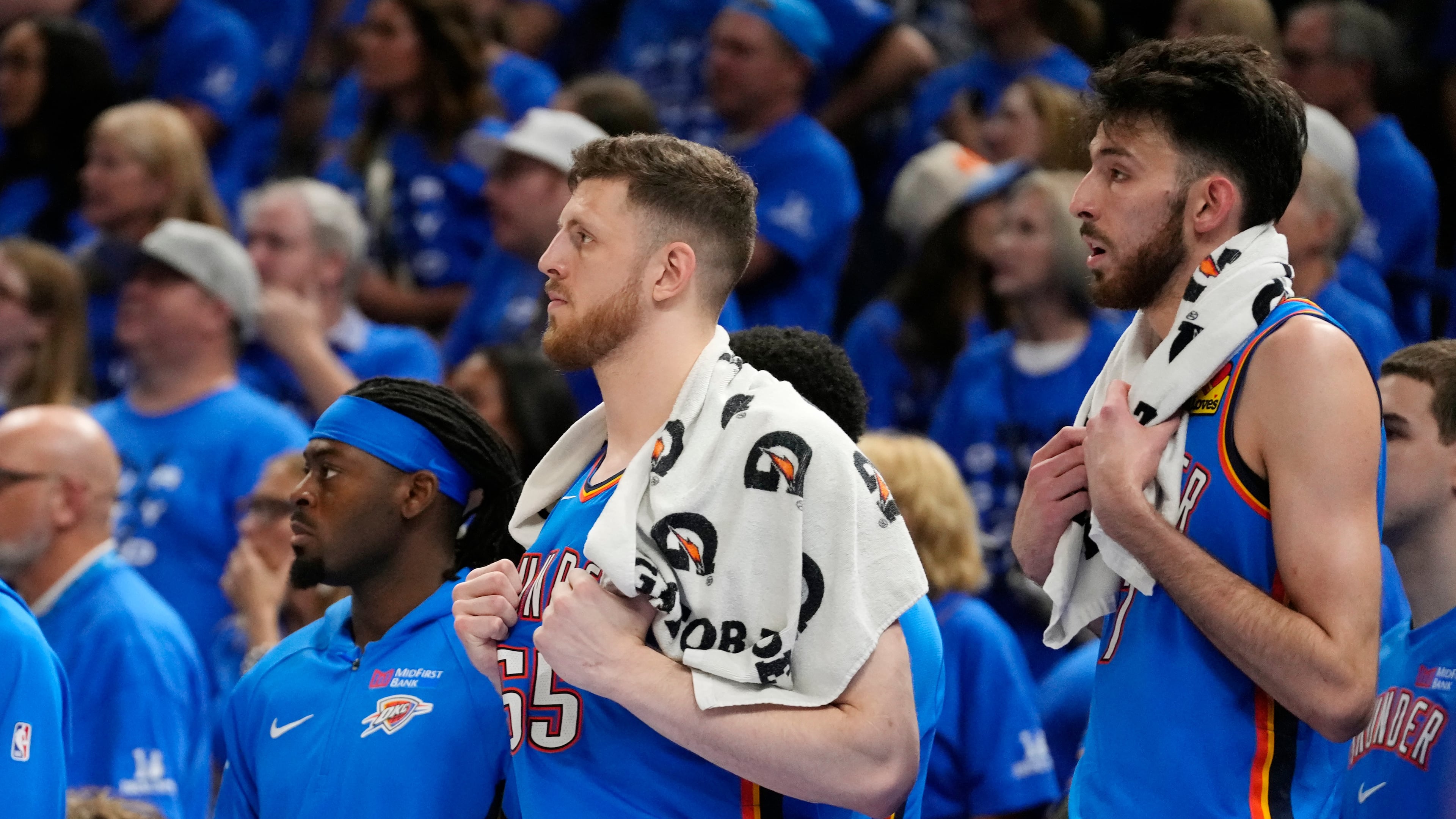 Oklahoma City Thunder guard Luguentz Dort, left, and Thunder centers Isaiah Hartenstein, center, and Chet Holmgren watch the action on the court from the team bench during the second half of Game 7 of the Western Conference finals of the NBA basketball playoffs series against the San Antonio Spurs, Saturday, May 30, 2026, in Oklahoma City. (AP Photo/Tony Gutierrez)