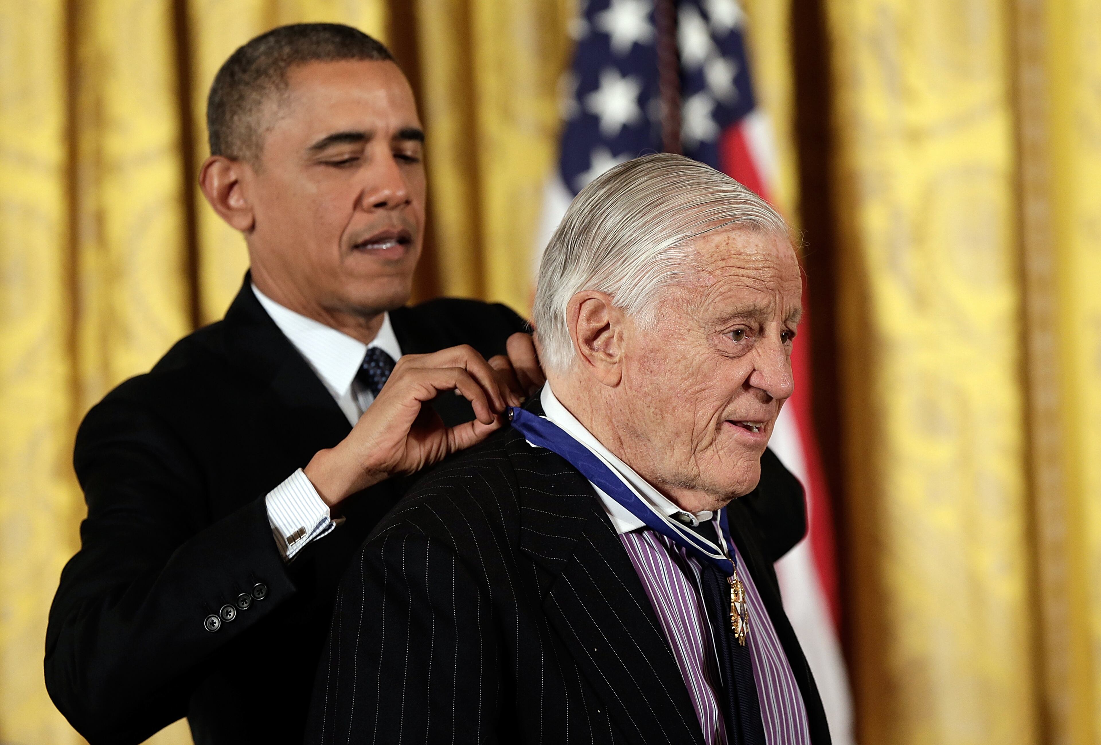 U.S. President Barack Obama awards the Presidential Medal of Freedom to Ben Bradlee, former Executive Editor of the Washington Post, in the East Room at the White House on November 20, 2013 in Washington, DC. The Presidential Medal of Freedom is the nation's highest civilian honor, presented to individuals who have made meritorious contributions to the security or national interests of the United States, to world peace, or to cultural or other significant public or private endeavors. (Photo by Win McNamee/Getty Images)
