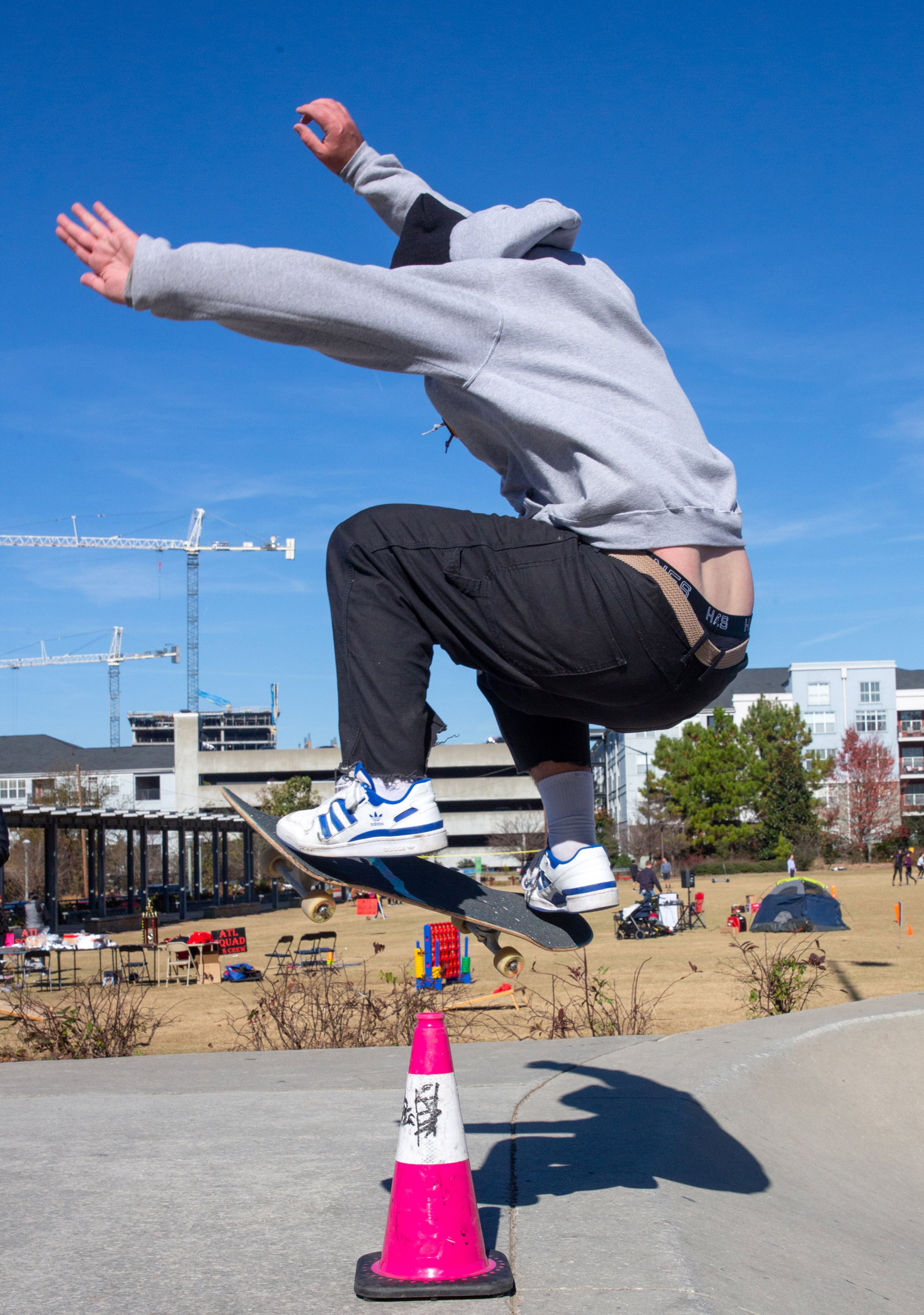Cole Henry jumps over a cone while coming out of one of the bowls at the Historic Fourth Ward Skate Park in Atlanta on Saturday, November 20, 2021. STEVE SCHAEFER FOR THE ATLANTA JOURNAL-CONSTITUTION