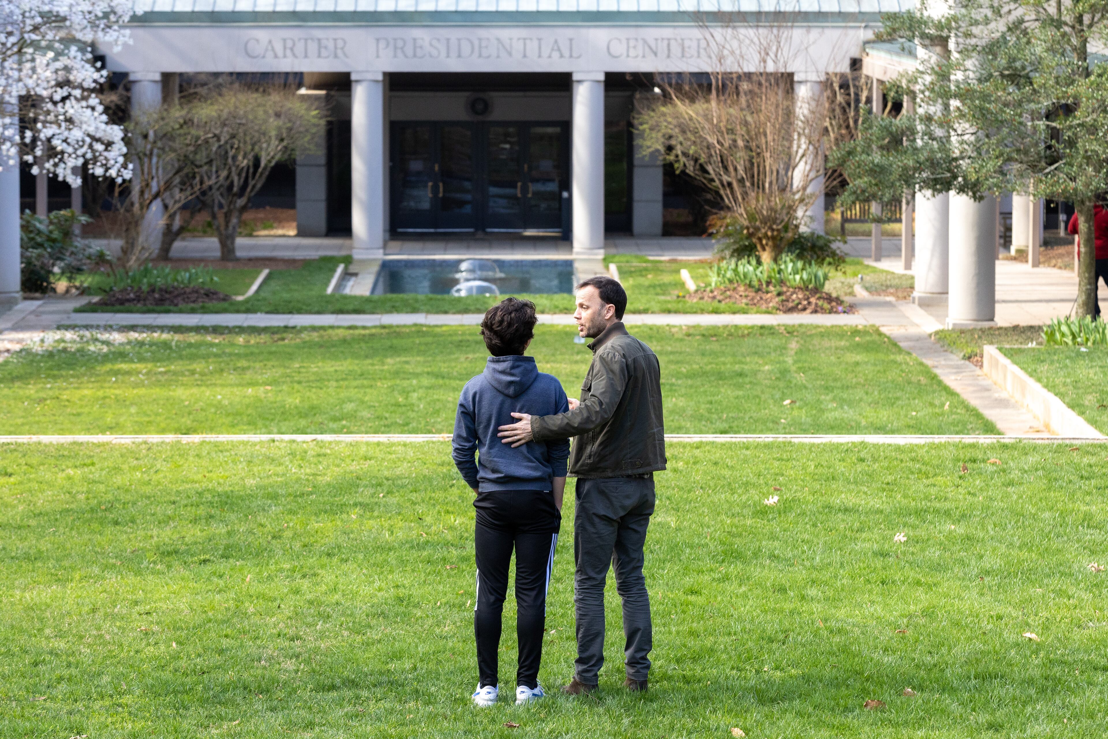 Paul Low and his son Gavin, 13, visiting from South Carolina, came to the Carter Center in Atlanta on Sunday morning, Feb. 19, 2023, after hearing that former President Jimmy Carter, 98, is under hospice care. (Photo: Steve Schaefer / steve.schaefer@ajc.com)