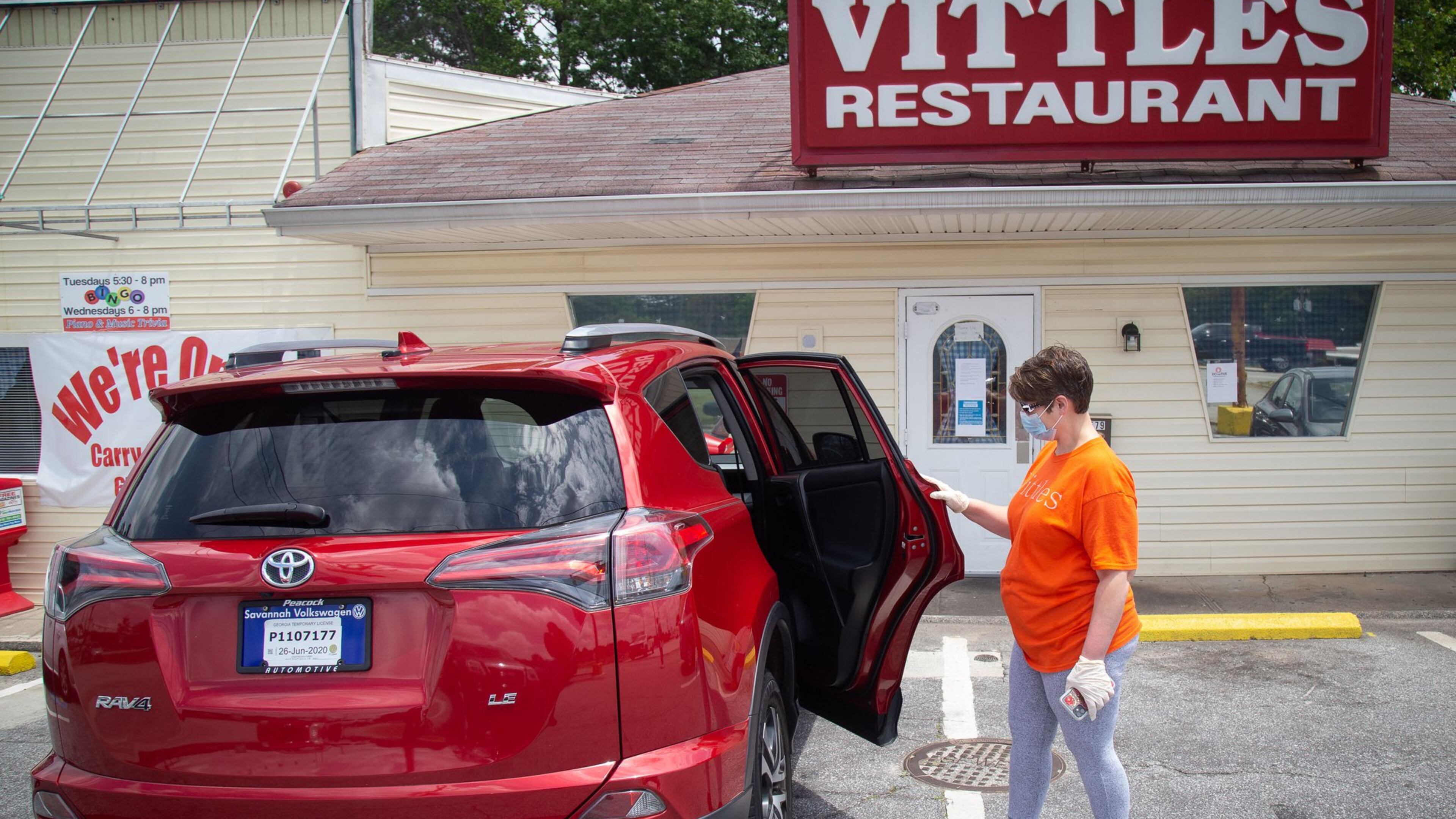 Vittles Restaurant owner Charity Salyers looks over her new 2017 Toyota Rav 4 outside her Smyrna restaurant Thursday, May 14, 2020. STEVE SCHAEFER FOR THE ATLANTA JOURNAL-CONSTITUTION