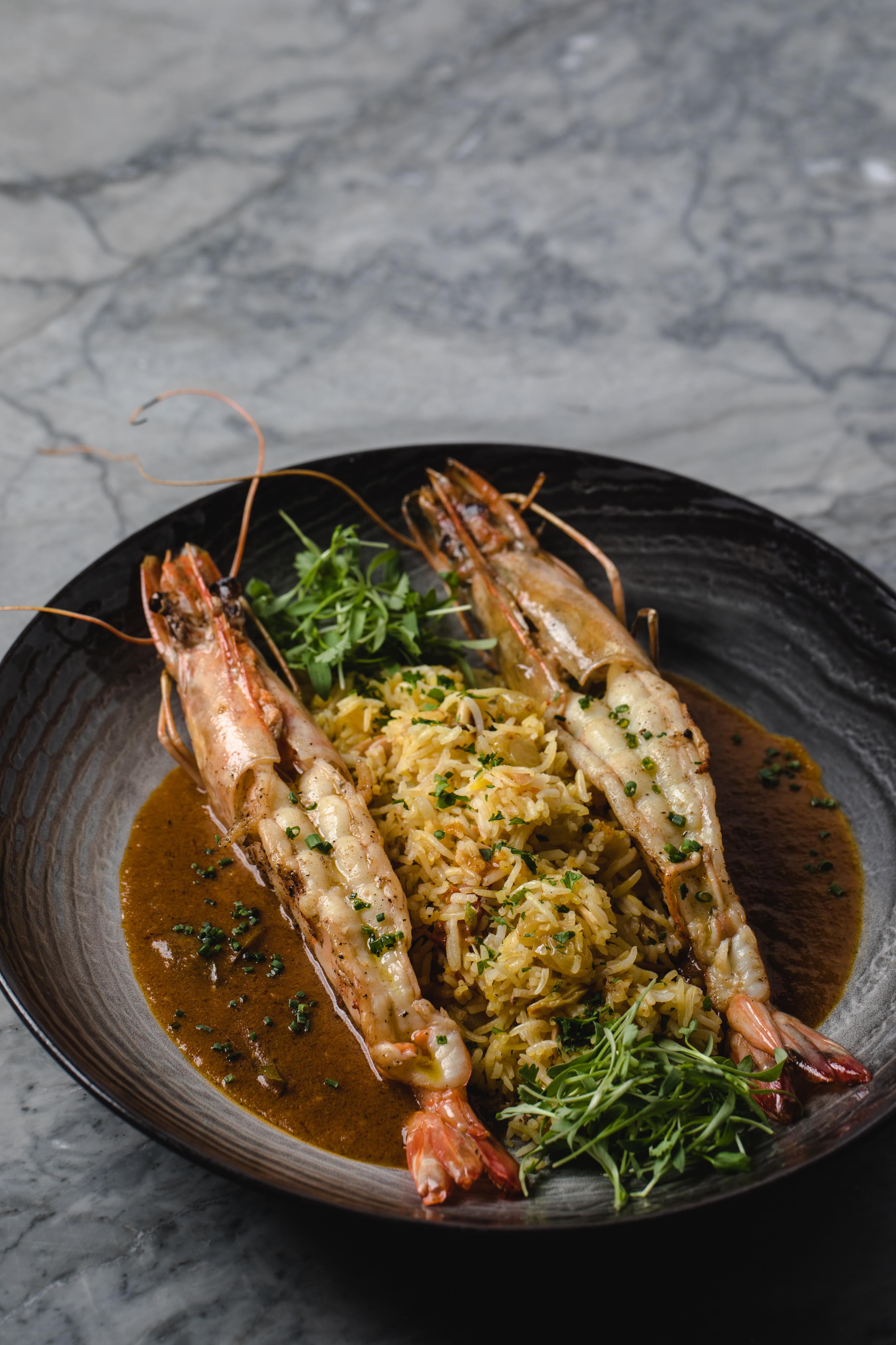 Giant prawns in coconut curry from Fia. (Erik Meadows Photography / Courtesy of Fia Restaurant)