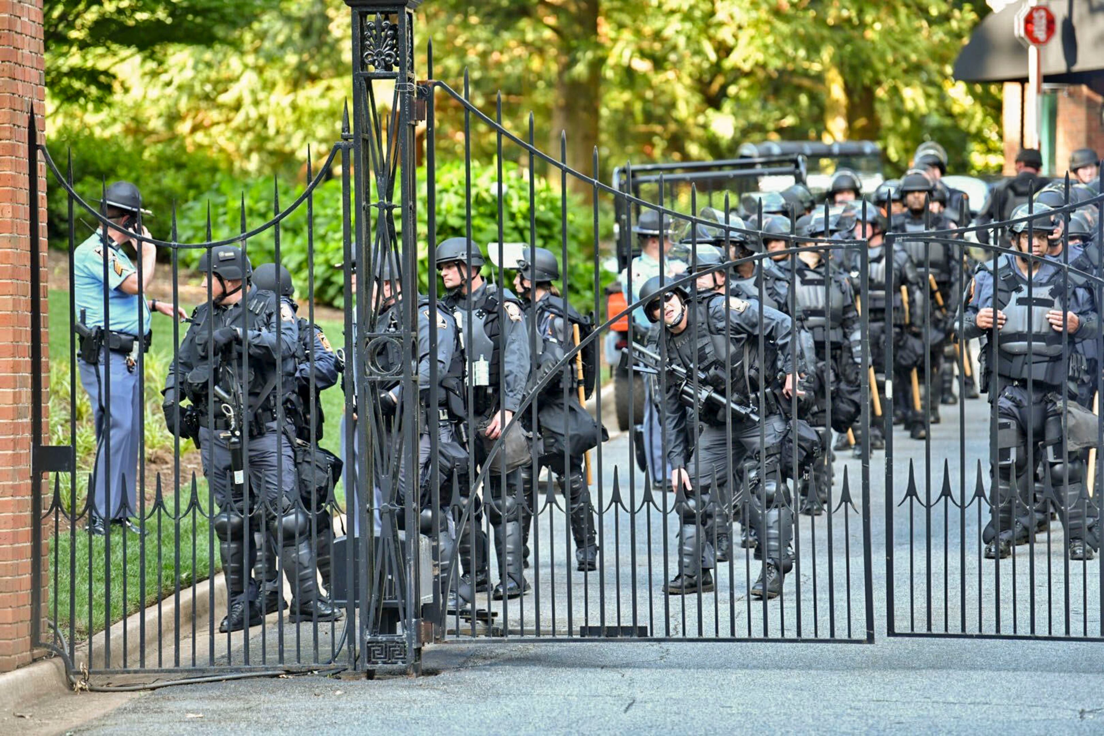 May 30, 2020 - Atlanta - SWAT team members standby inside the gate of the Governor's mansion as protestors line the street in front of the Governor's mansion on Saturday as protests began for a second day. Protests over the death of George Floyd in Minneapolis police custody spread around the United States on Saturday, as his case renewed anger about others involving African Americans, police and race relations. Hyosub Shin / hyosub.shin@ajc.com