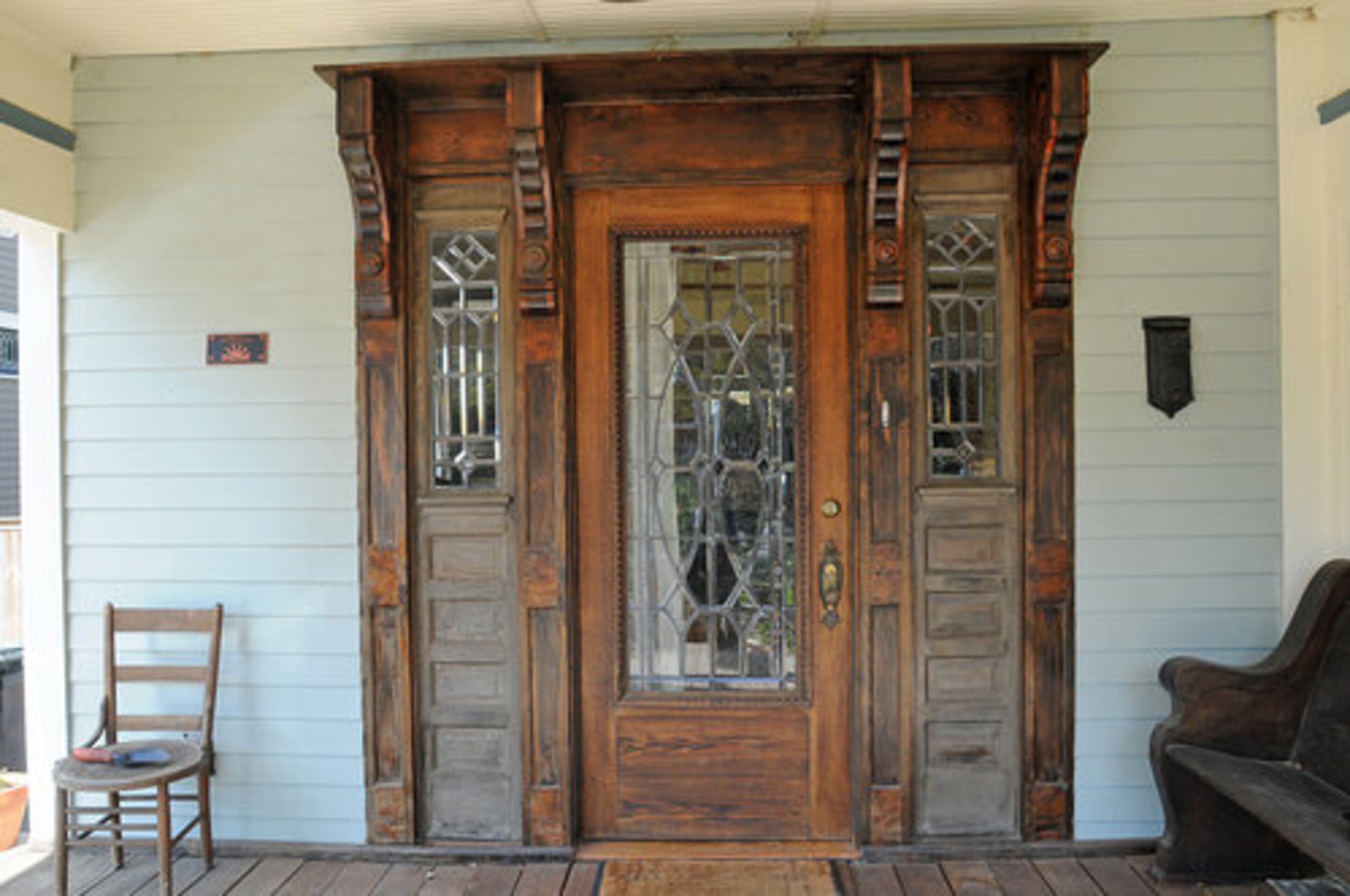 "The front door is a salvaged 1890s oak door with beveled and leaded glass that hailed from Ohio and had been restored. The sidelights are from upstate New York but had the same look and feel. The fleur de lys brackets and side paneling our cabinet guy milled from beams that we took out of the back of the house and are both heart of pine and cedar. We got the design from other Ruggles' built homes in the neighborhood to keep the look authentic and appropriate," said Kara O'Brien.