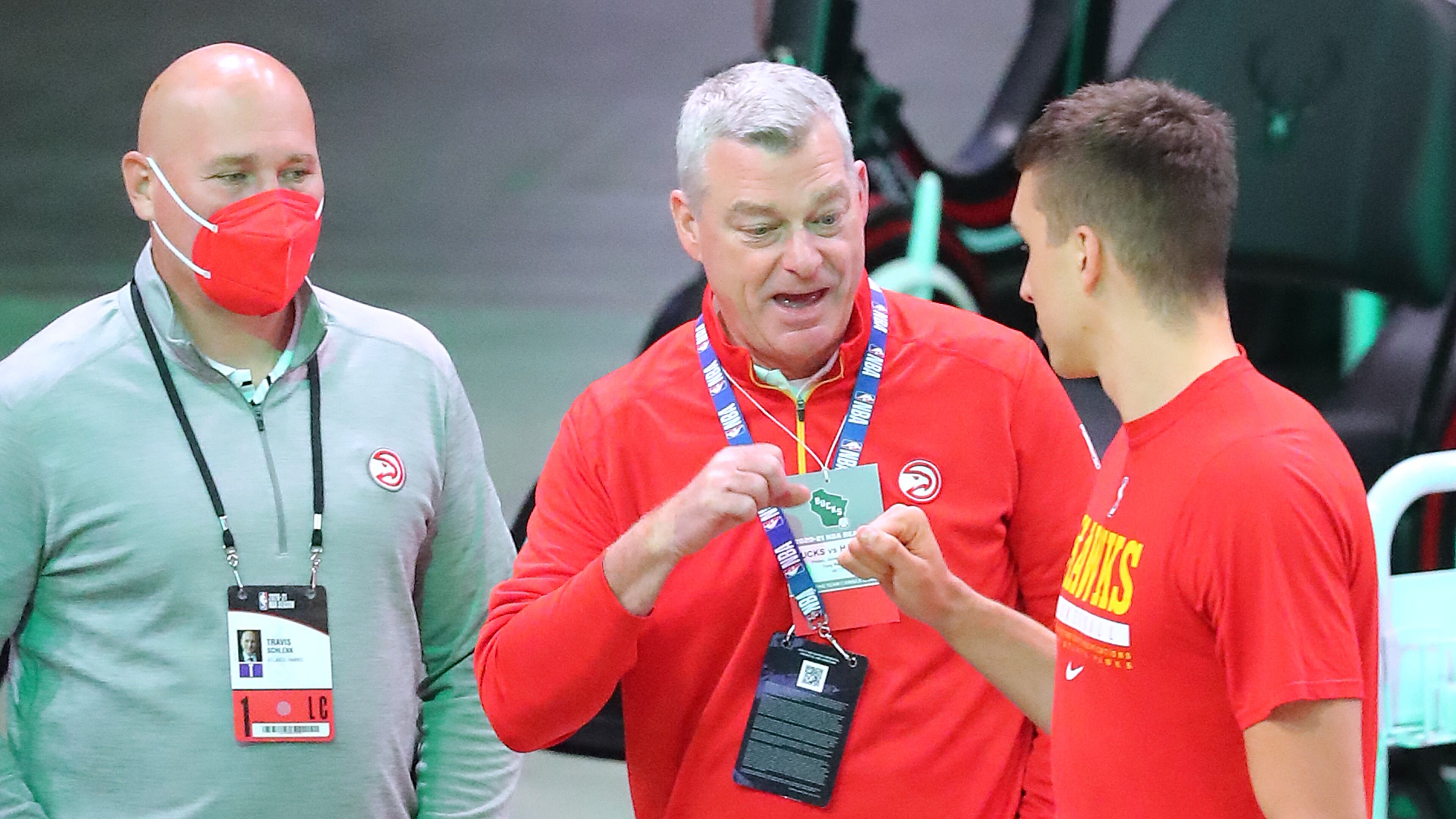 Atlanta Hawks guard Bogan Bogdanovic gives owner Tony Ressler a fist bump with general manager & president Travis Schlenk looking on as he takes the court for warm ups before playing the Milwaukee Bucks in Game 2 of the NBA Eastern Conference Finals on Friday, June 25, 2021, in Milwaukee. Curtis Compton / Curtis.Compton@ajc.com