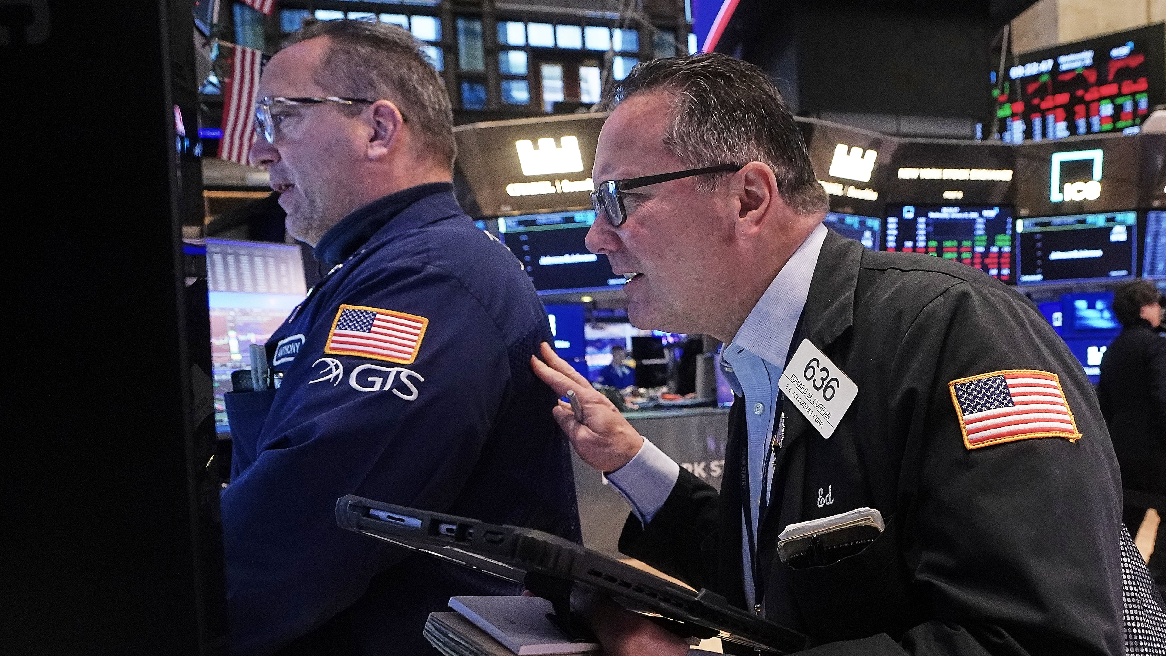 Specialist Anthony Matesic, left, and trader Edward Curran work on the floor of the New York Stock Exchange, Wednesday, Jan. 21, 2026. (AP Photo/Richard Drew)