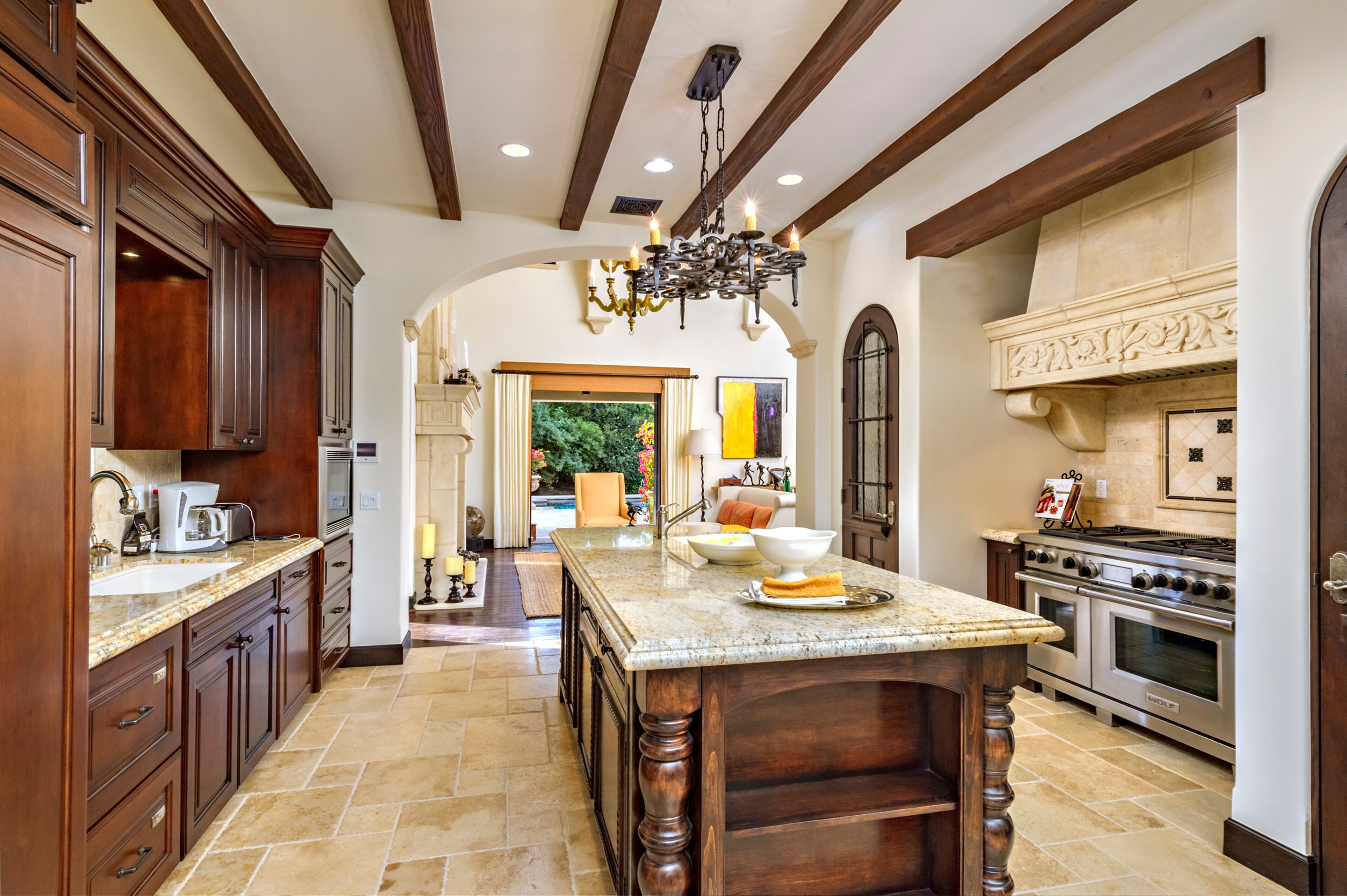 The spacious kitchen features a large wood-and-stone island and it comes with plenty of storage space for wine. Rocky star and all-around action movie legend Sylvester Stallone has put his desert home in a gated La Quinta, Calif., community up for sale at $4.2 million. The 5,173-square-foot, four-bedroom, 4.5-bathroom home features details such as arched doorways, exposed beams, and plenty of space to hang his paintings, since he’s not just an actor—he’s an artist, too. Listing courtesy of Josh Reef, Hurwitz James Company