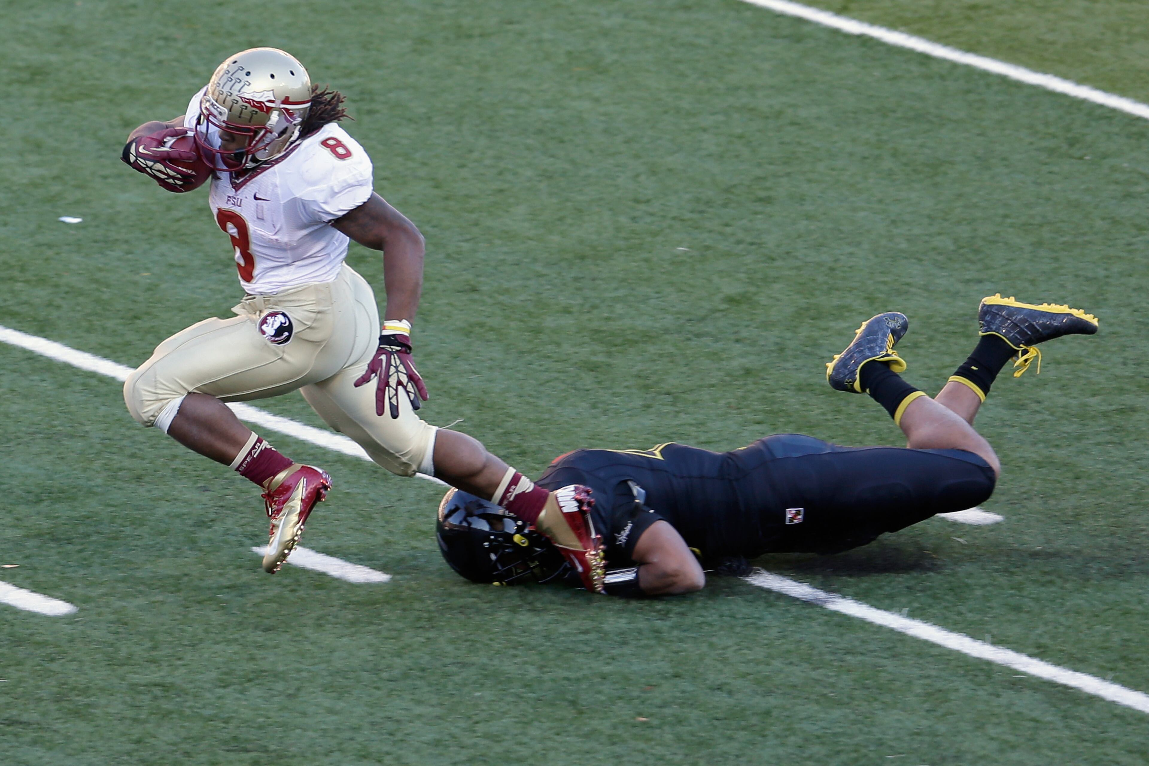 Running back Devonta Freeman #8 of the Florida State Seminoles is tackled by defensive back Matt Robinson #40 of the Maryland Terrapins during the third quarter at Byrd Stadium on November 17, 2012 in College Park, Maryland. (Photo by Rob Carr/Getty Images)