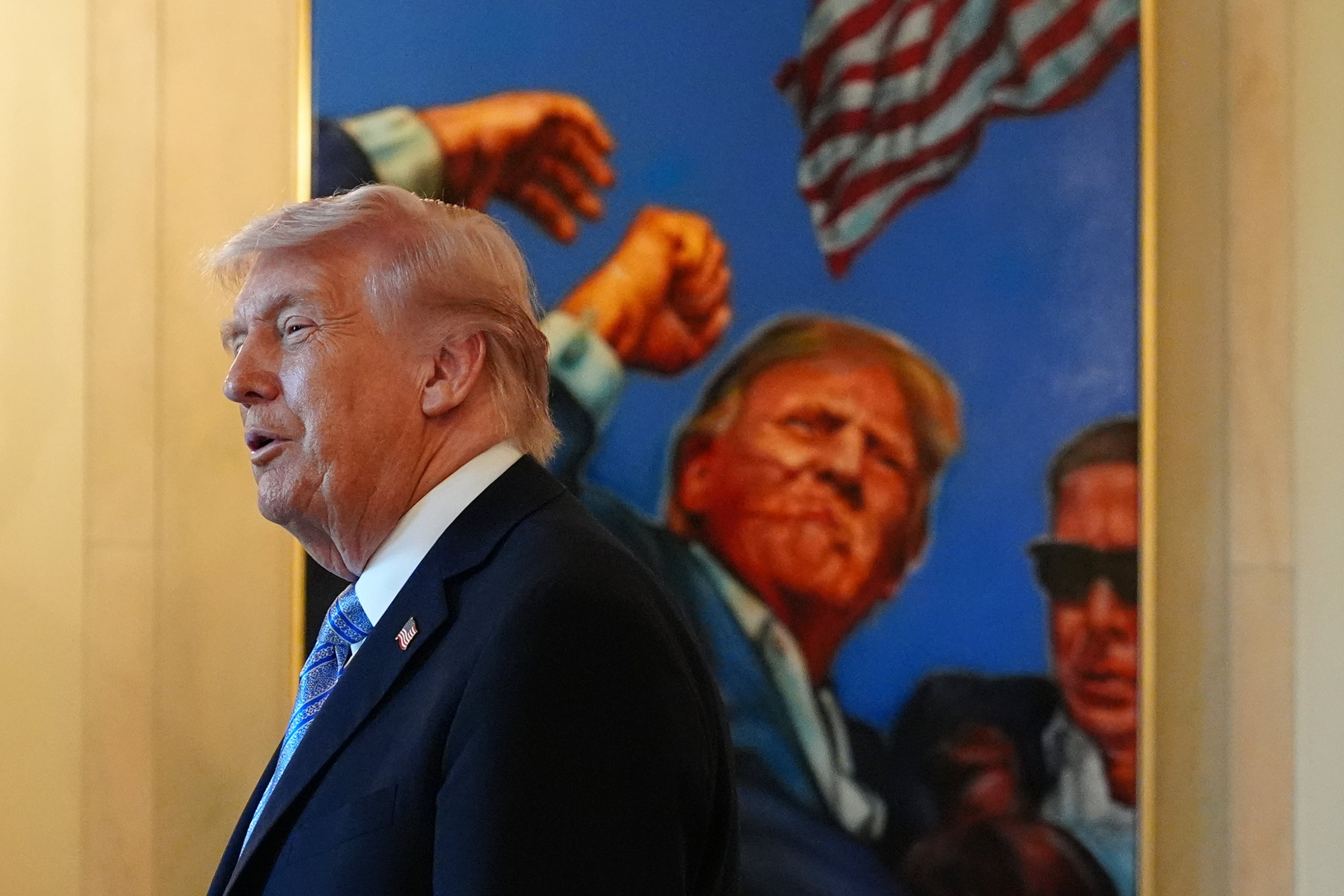 President Donald Trump talks with small business owners in the Grand Foyer of the White House on Monday. (Jacquelyn Martin/AP)