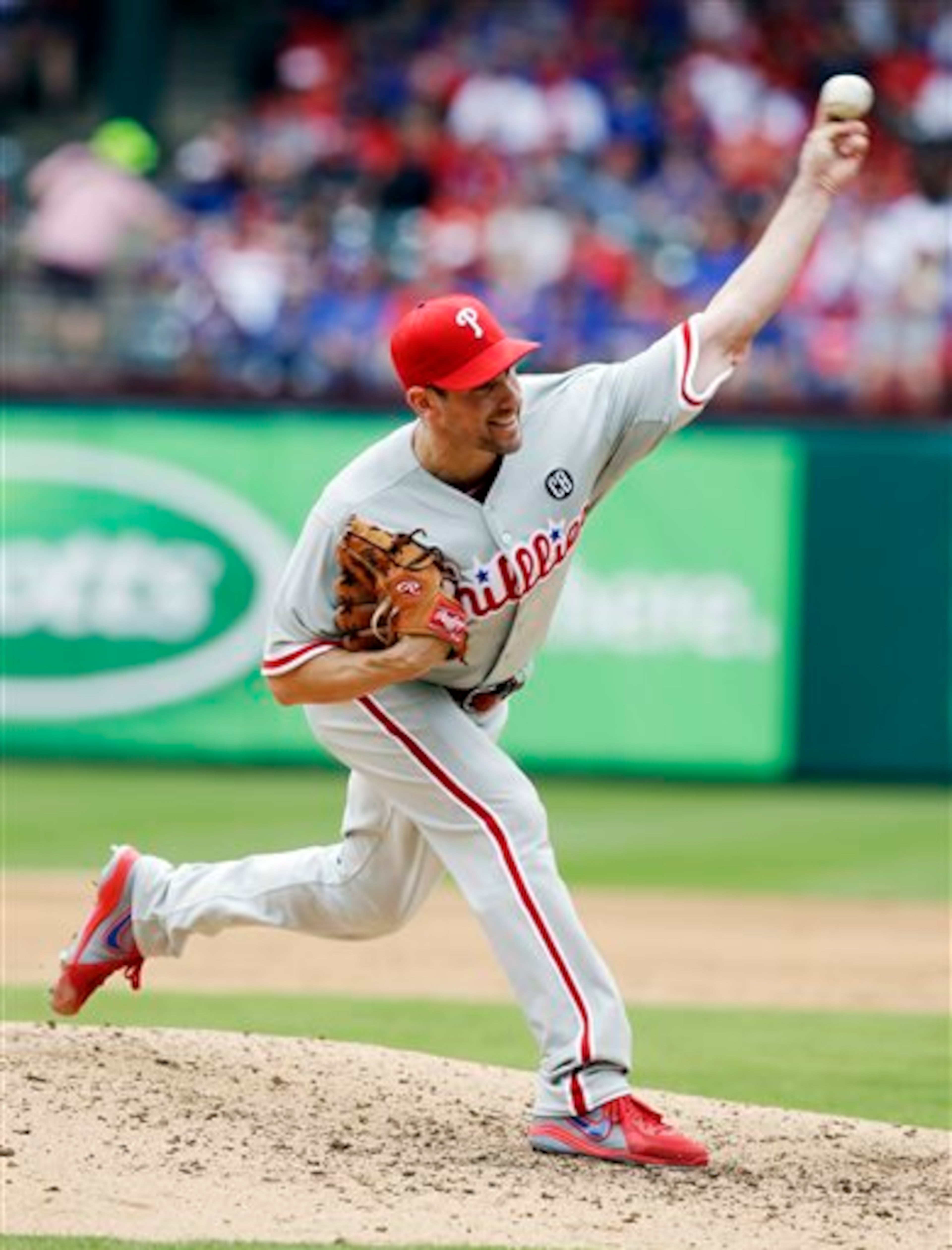 Philadelphia Phillies starting pitcher Cliff Lee delivers the ball during the third inning of an opening day baseball game against the Texas Rangers at Globe Life Park, Monday, March 31, 2014, in Arlington, Texas. (AP Photo/Tony Gutierrez)