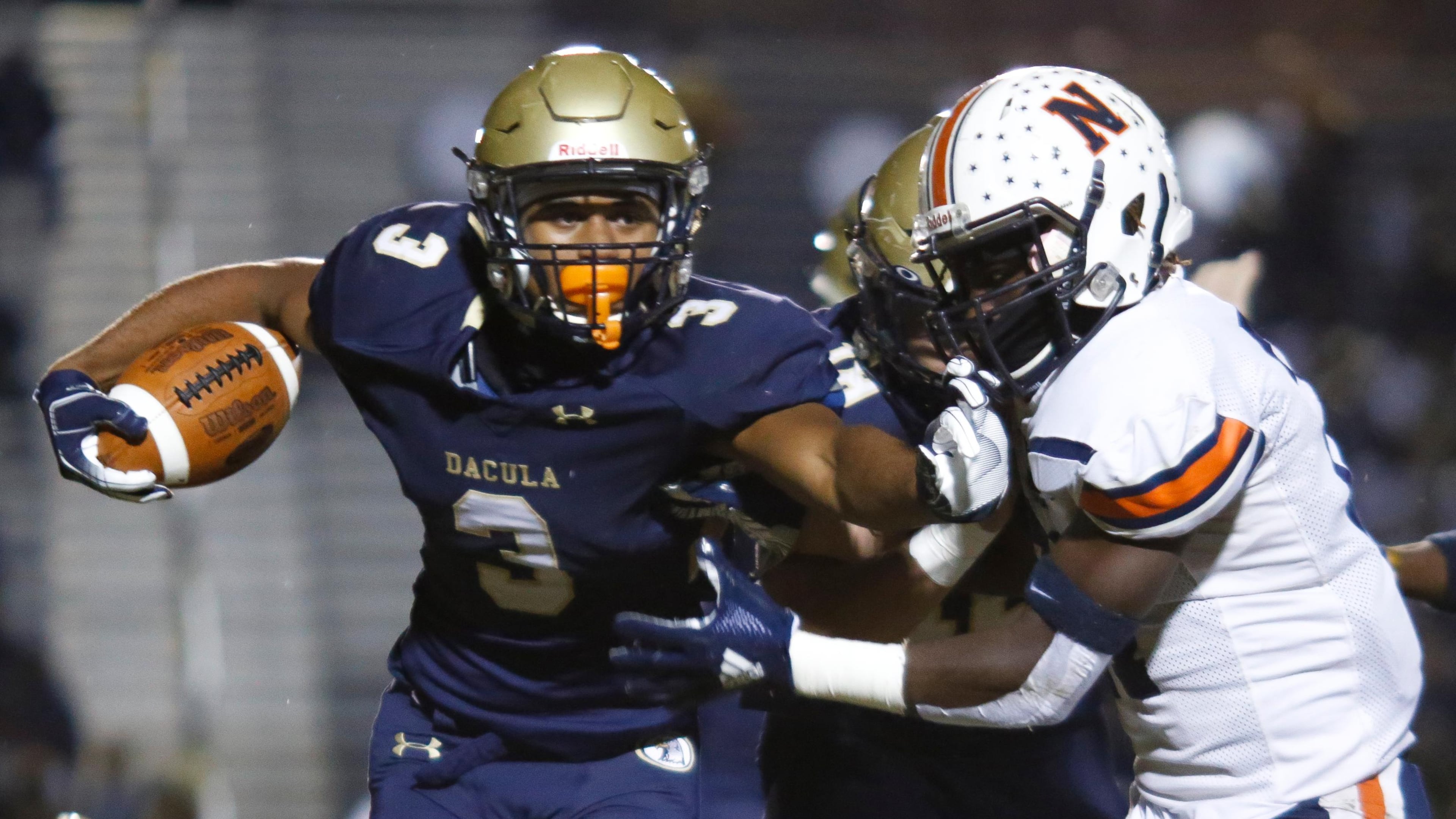 Dacula's Jalen Perry (3) pushes away a Northside defender during the first half of Friday's Class AAAAAA semifinal in Dacula. (Casey Sykes/Special)