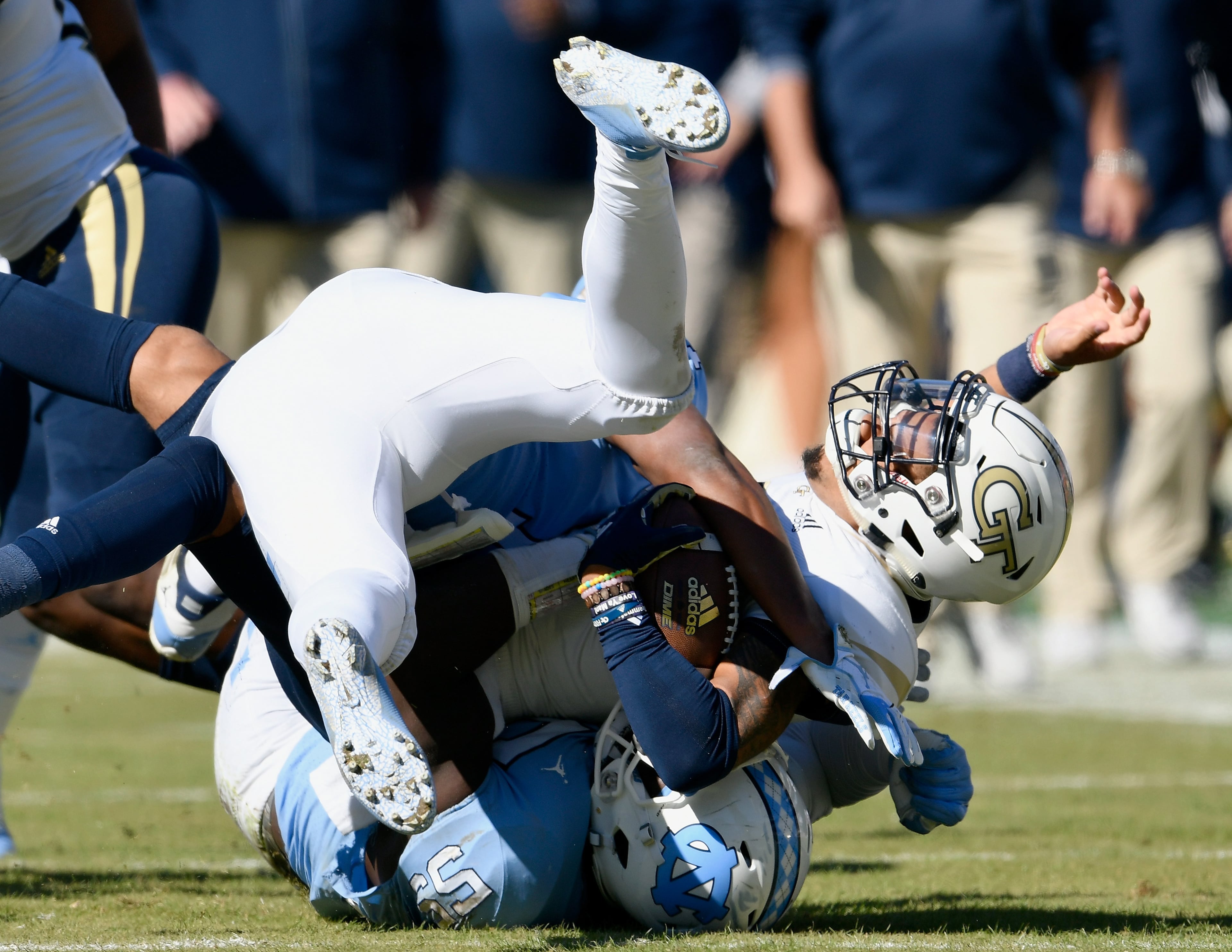 CHAPEL HILL, NC - NOVEMBER 03: Malik Carney #53 of the North Carolina Tar Heels tackles Tobias Oliver #8 of the Georgia Tech Yellow Jackets in the first half of their game at Kenan Stadium on November 3, 2018 in Chapel Hill, North Carolina. (Photo by Grant Halverson/Getty Images)