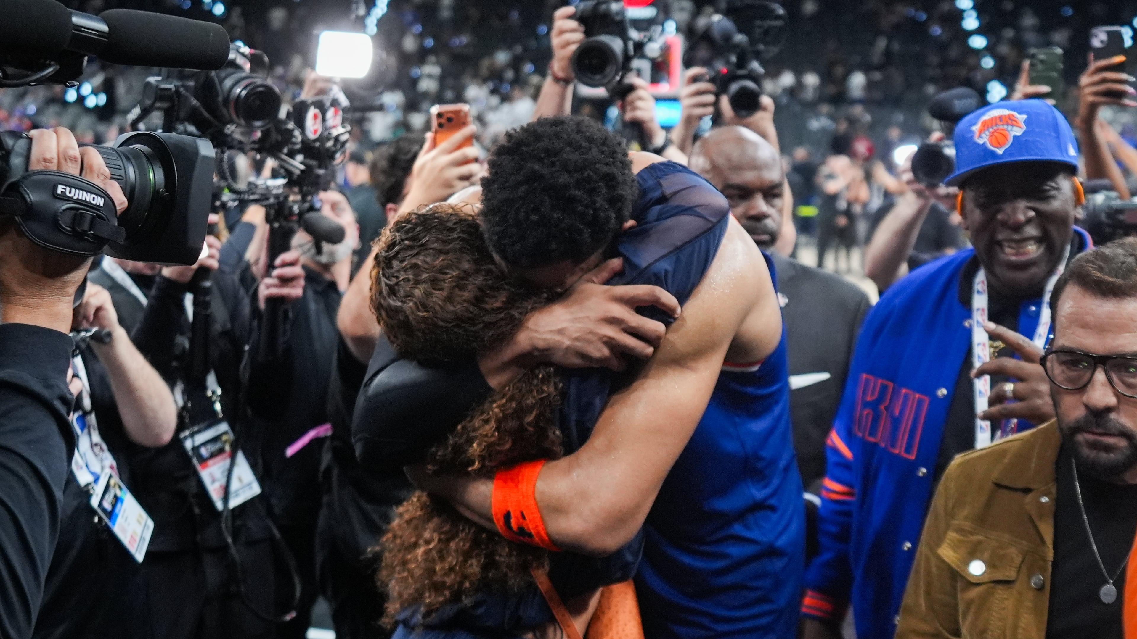 New York Knicks center Karl-Anthony Towns is embraces as he leaves the court after Game 2 of the NBA Finals basketball series against the San Antonio Spurs, Friday, June 5, 2026, in San Antonio. (AP Photo/Eric Gay)