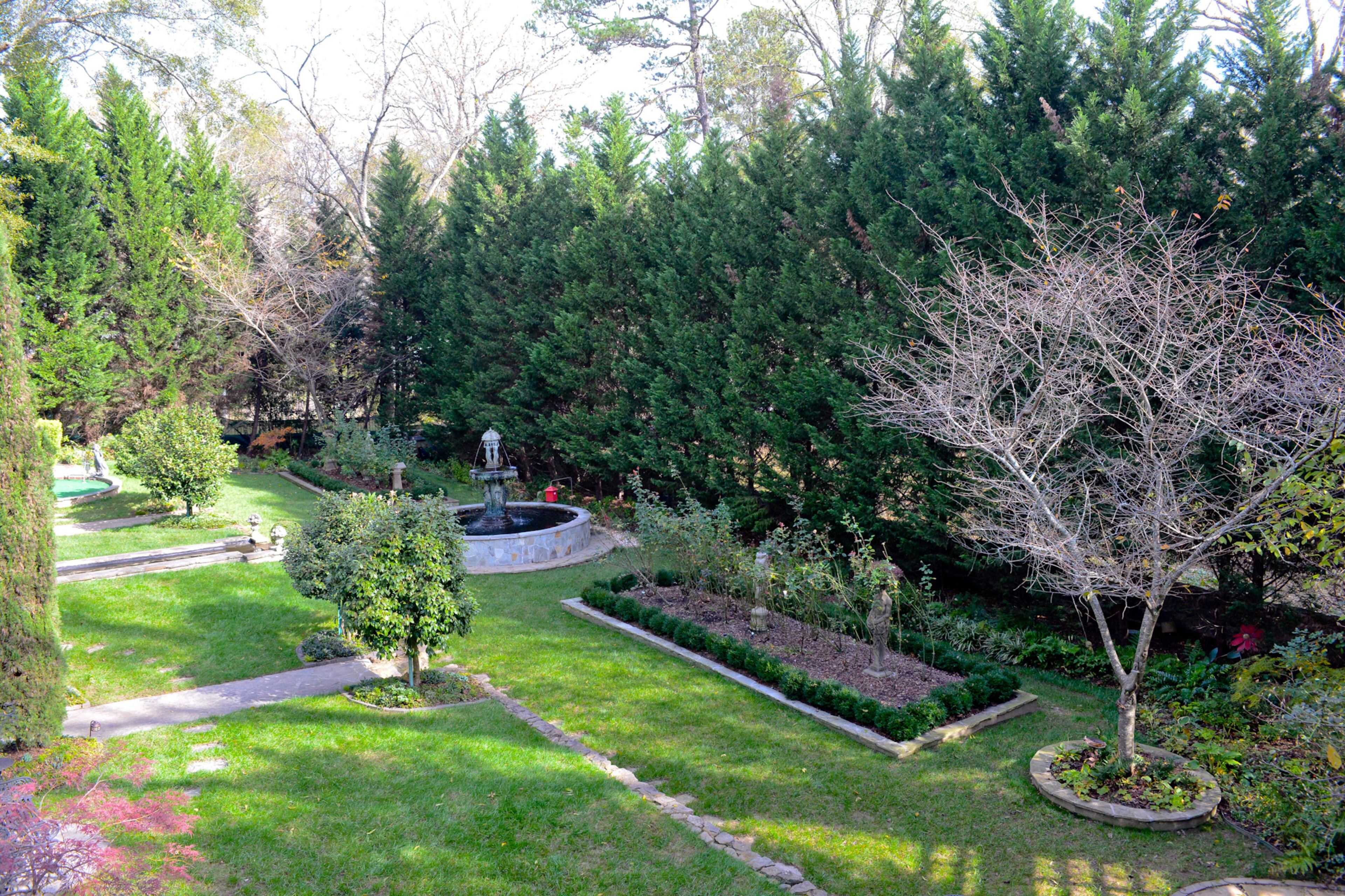 The carriage house view of Keenan Nix's meticulously manicured gardens beckons guests to settle in for a nice, long stay.