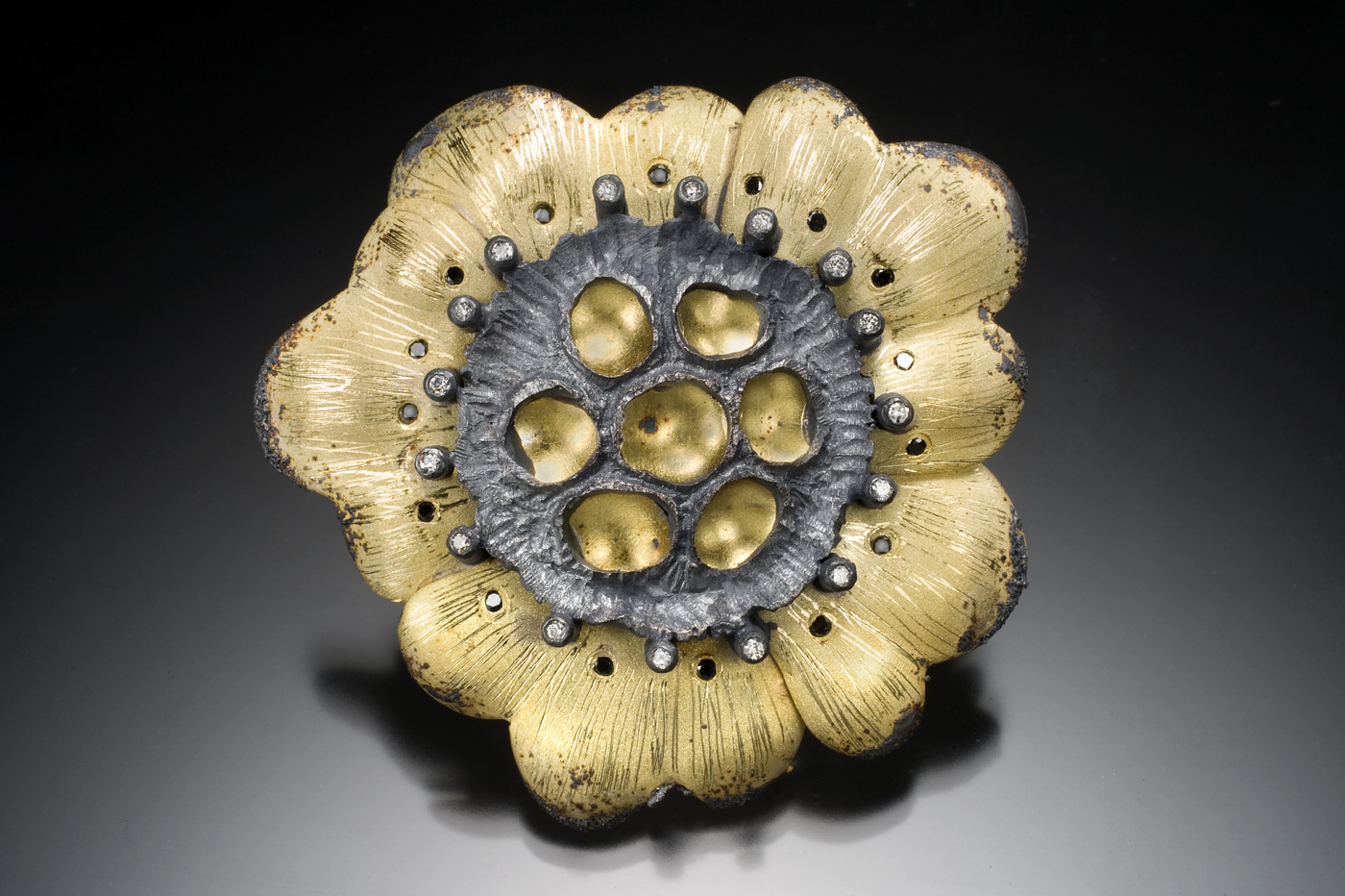 Rebecca Meyers of Baltimore will show jewelry including this poppy pendant and brooch (from gold and oxidized silver with black and white diamonds).