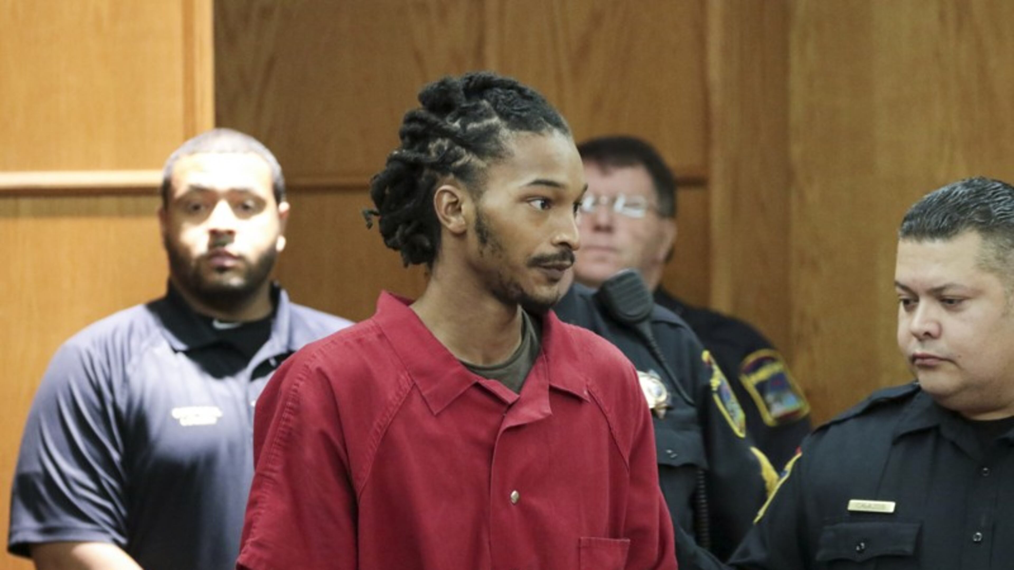Johnthony Walker is escorted into a courtroom in Chattanooga, Tenn. Walker was the driver of a Chattanooga school bus crash that killed six children in November. (Dan Henry/Chattanooga Times Free Press via AP)
