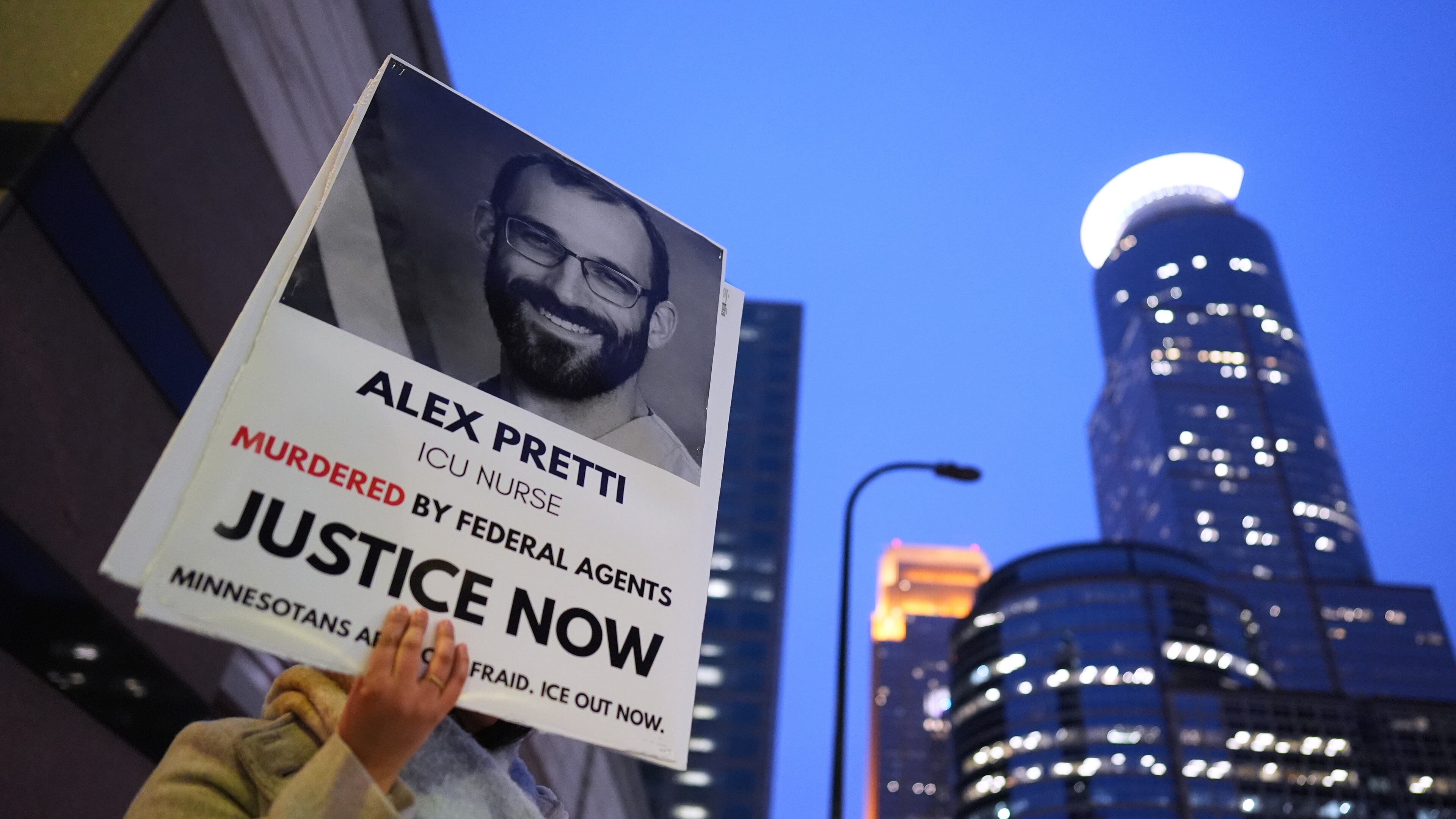 A person holds a sign of Alex Pretti during a protest outside the office of Sen. Amy Klobuchar, D-Minn., on Monday, Jan. 26, 2026, in Minneapolis. (AP Photo/Adam Gray)