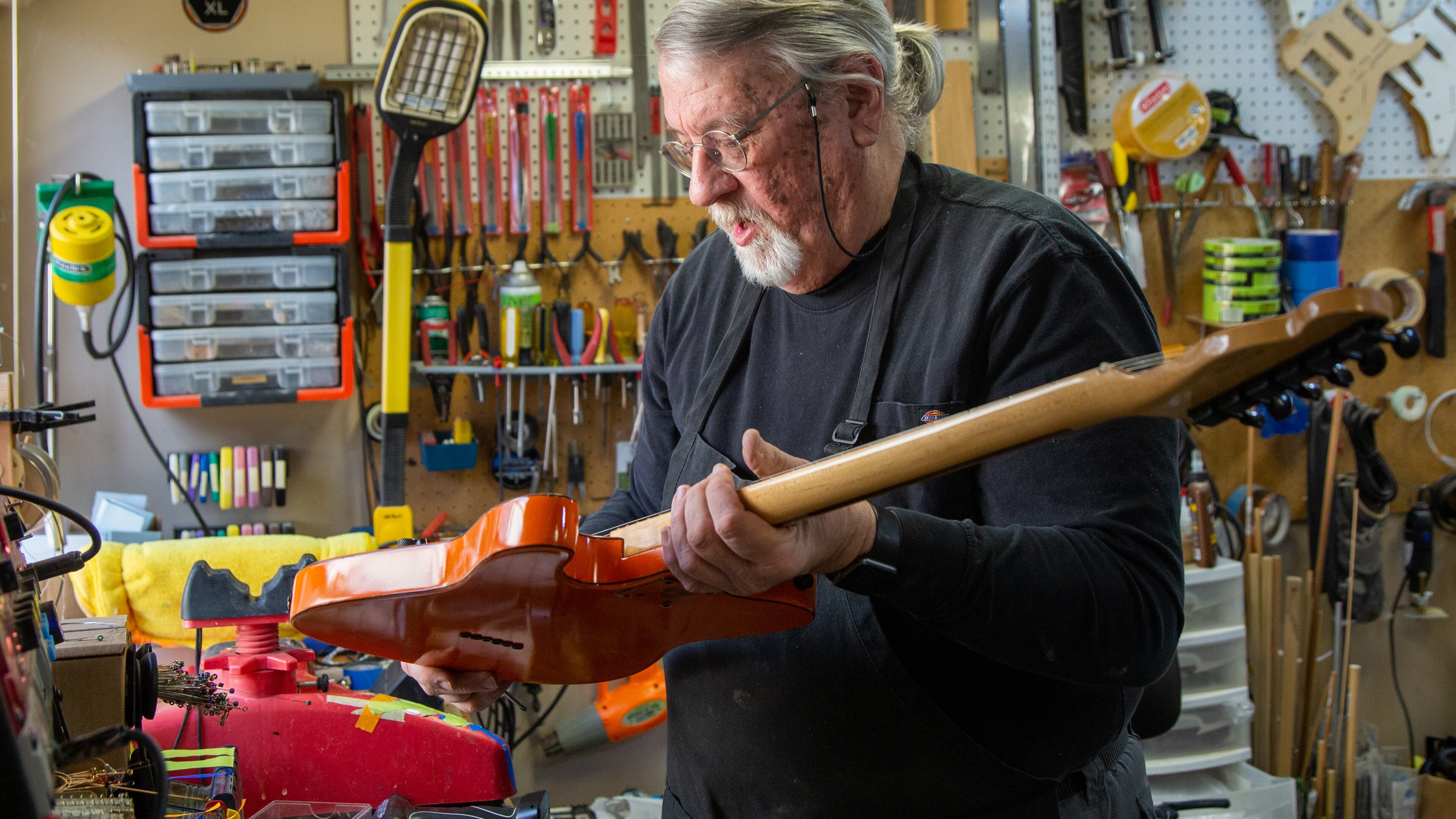 Bud Veazey works on a custom guitar in the basement workshop of his Lawrenceville home. He recently gave an electric guitar to a victim of the Nashville bombing who collection of guitars were destroyed. PHIL SKINNER FOR THE ATLANTA JOURNAL-CONSTITUTION.