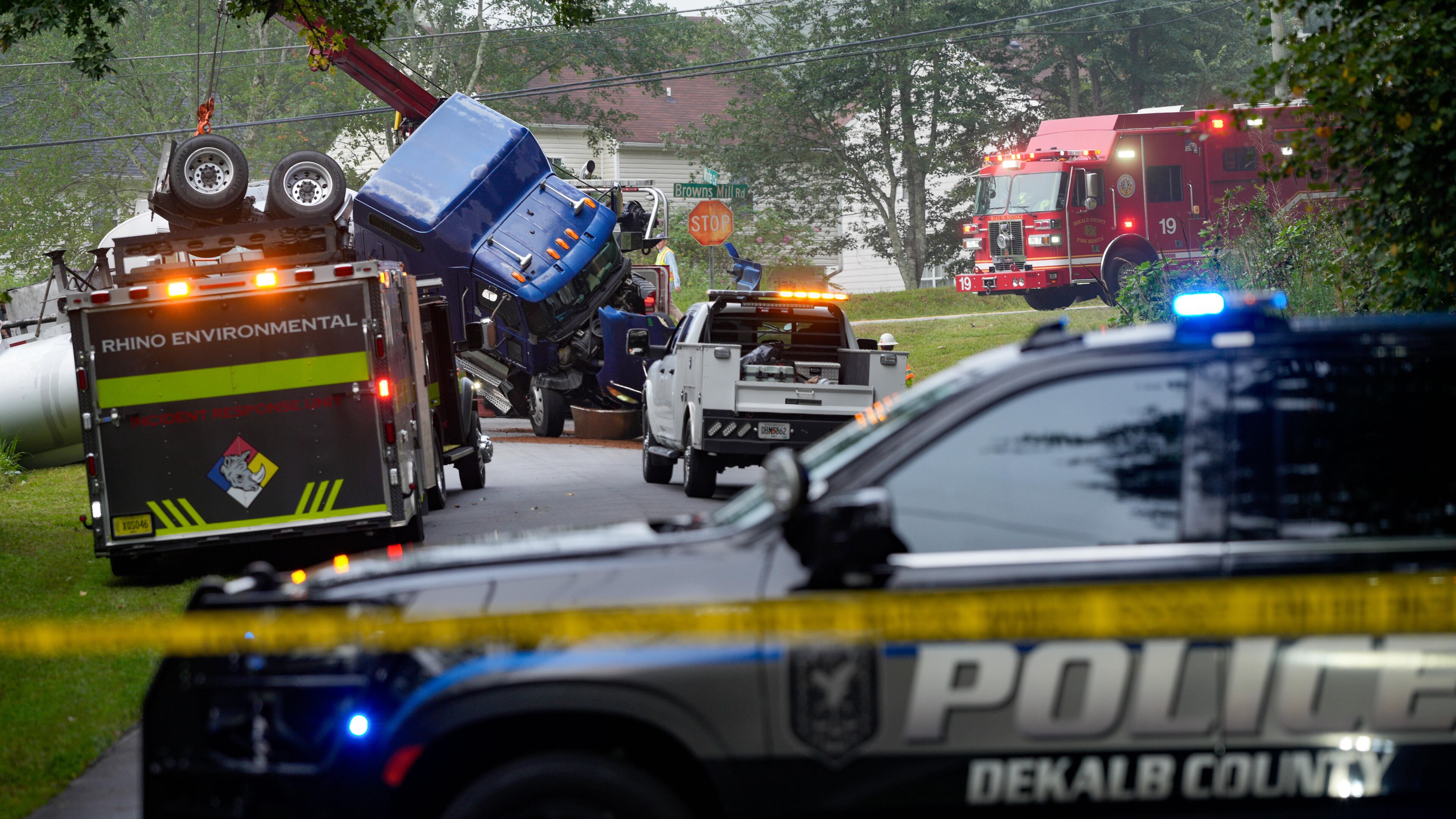 Parts of Browns Mill Road near White Circle were shut down in both directions on Friday, Aug. 28, 2026, as authorities addressed the overturned tanker truck. (Ben Hendren for the AJC)