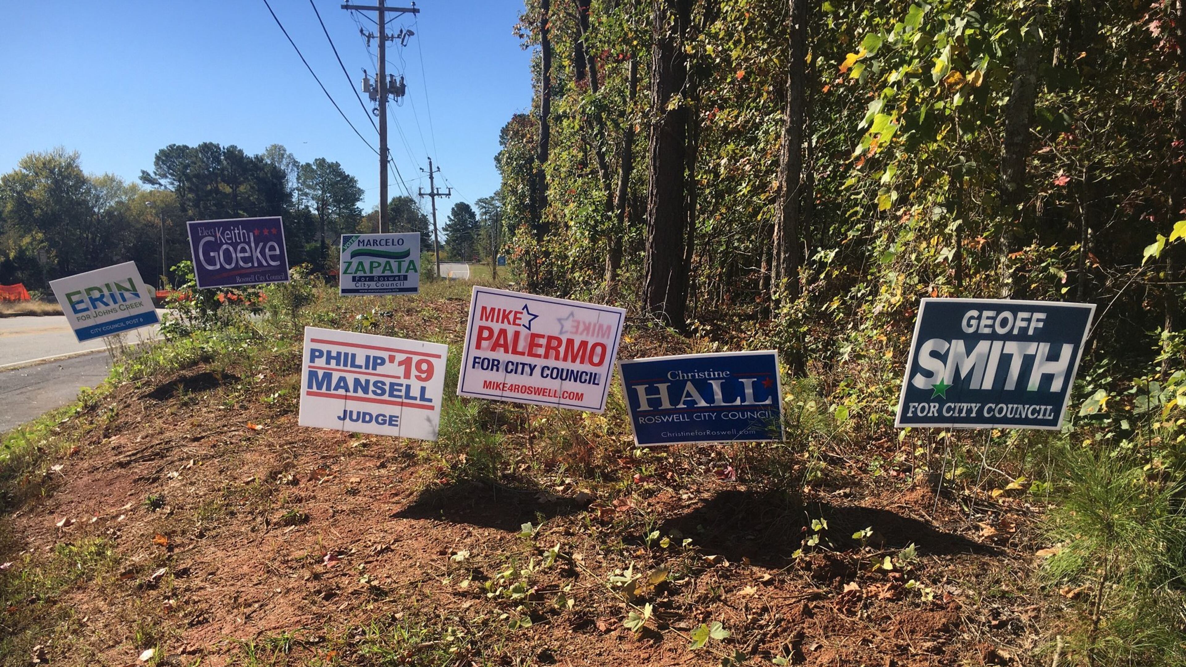 These were some of the 57 campaign signs bordering the East Roswell Library, on Wednesday, Oct. 23, 2019. The library is one of the city’s two early voting locations. Election day is Nov. 5, 2019. (Ben Brasch/AJC)