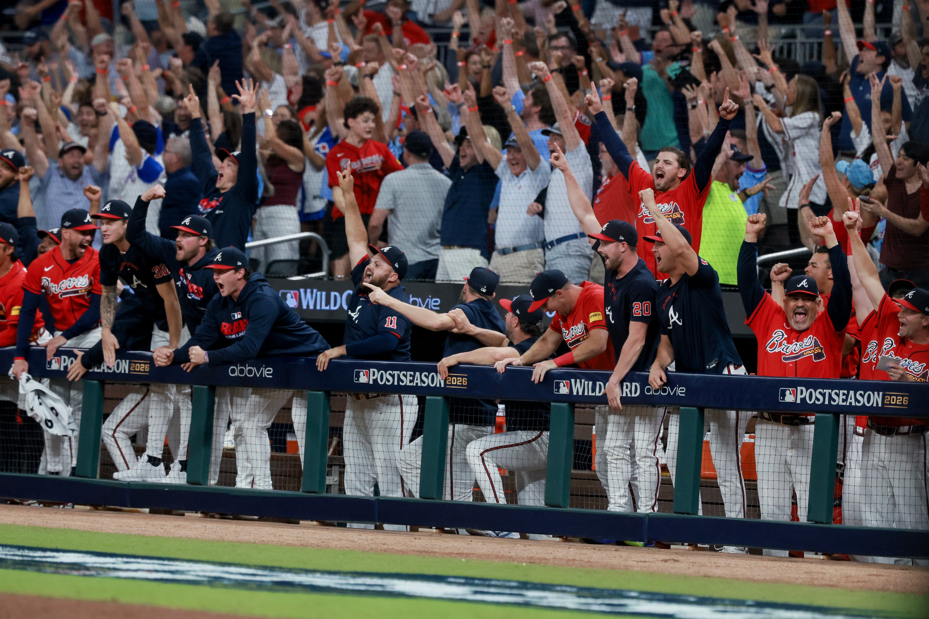 Fans and players celebrate after Braves center fielder Michael Harris II hits a three-run home run against the Phillies during Game 3 of their National League Wild Card Series on Thursday, Oct. 1, 2026, in Atlanta. (Jason Getz/AJC)
