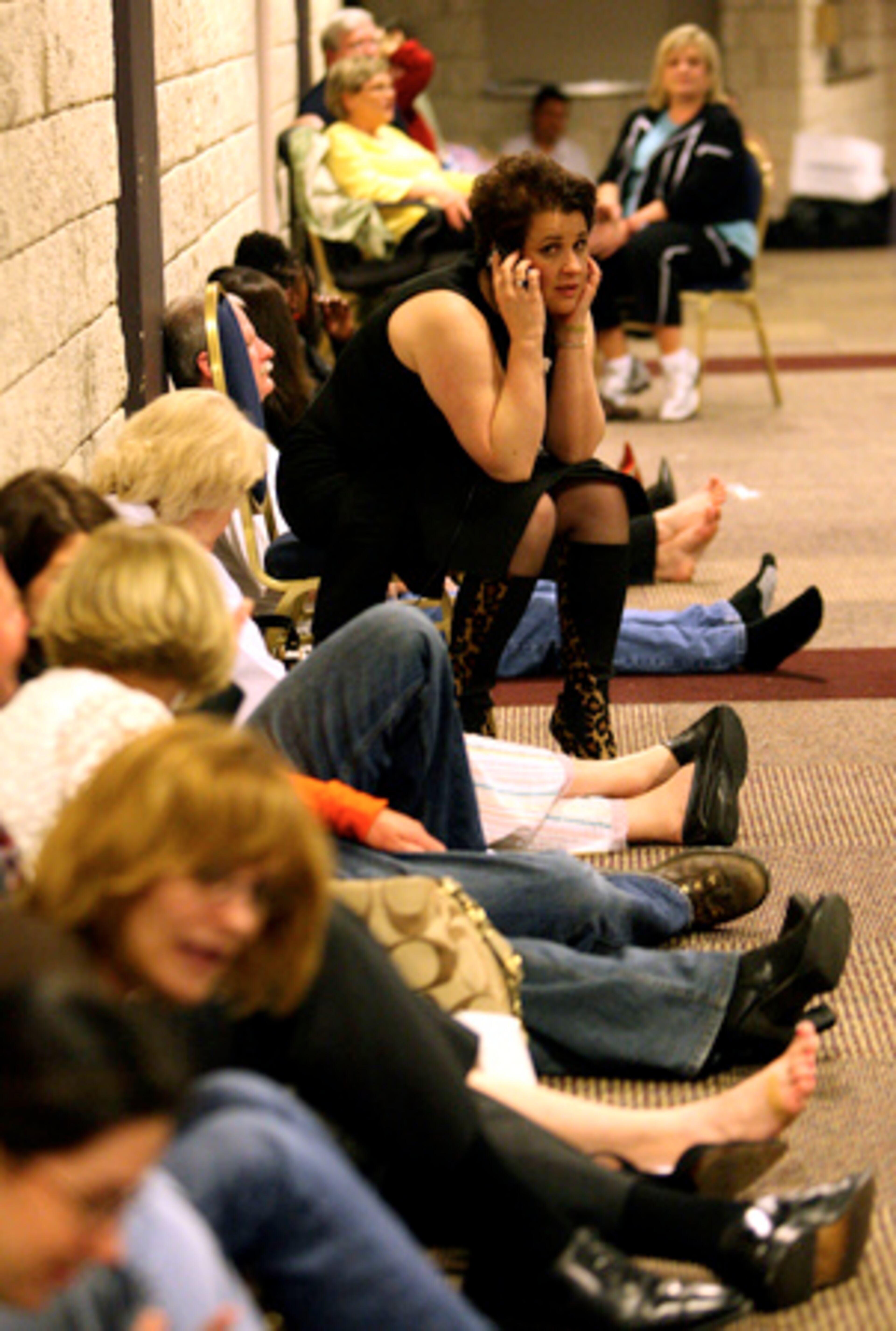 Rhonda Mullins, of Canton, talks to her husband on the phone while waiting in the basement of the Omni Hotel in downtown Atlanta for the all clear following sever weather that rolled through Friday night. Mullins was at the hotel for a dental convention.