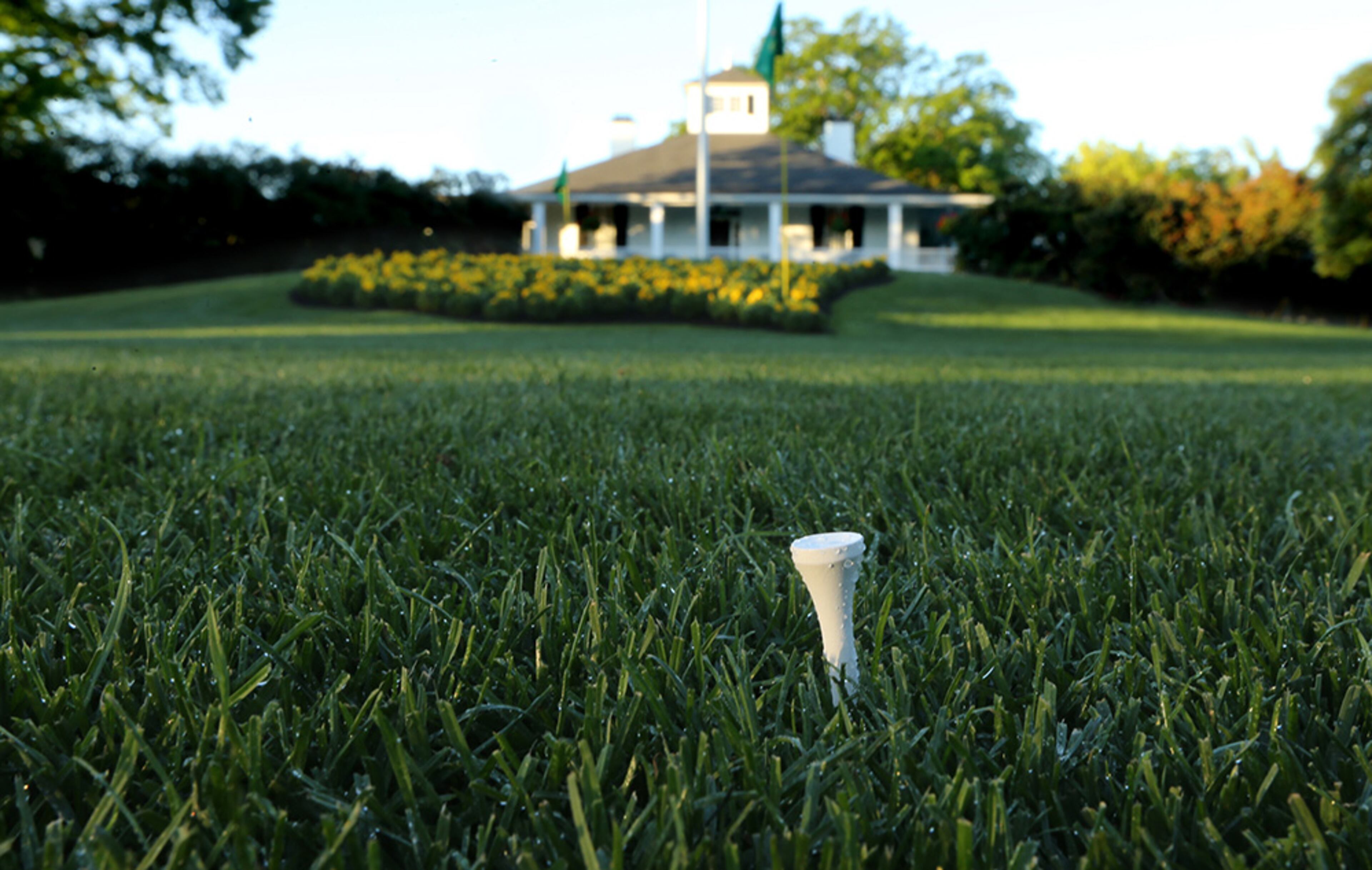 A golf fan leaves a tee stuck in the grass as a quiet testament to the game of golf in front of the clubhouse at Augusta National Golf Club on Tuesday, April 5, 2016, in Augusta.