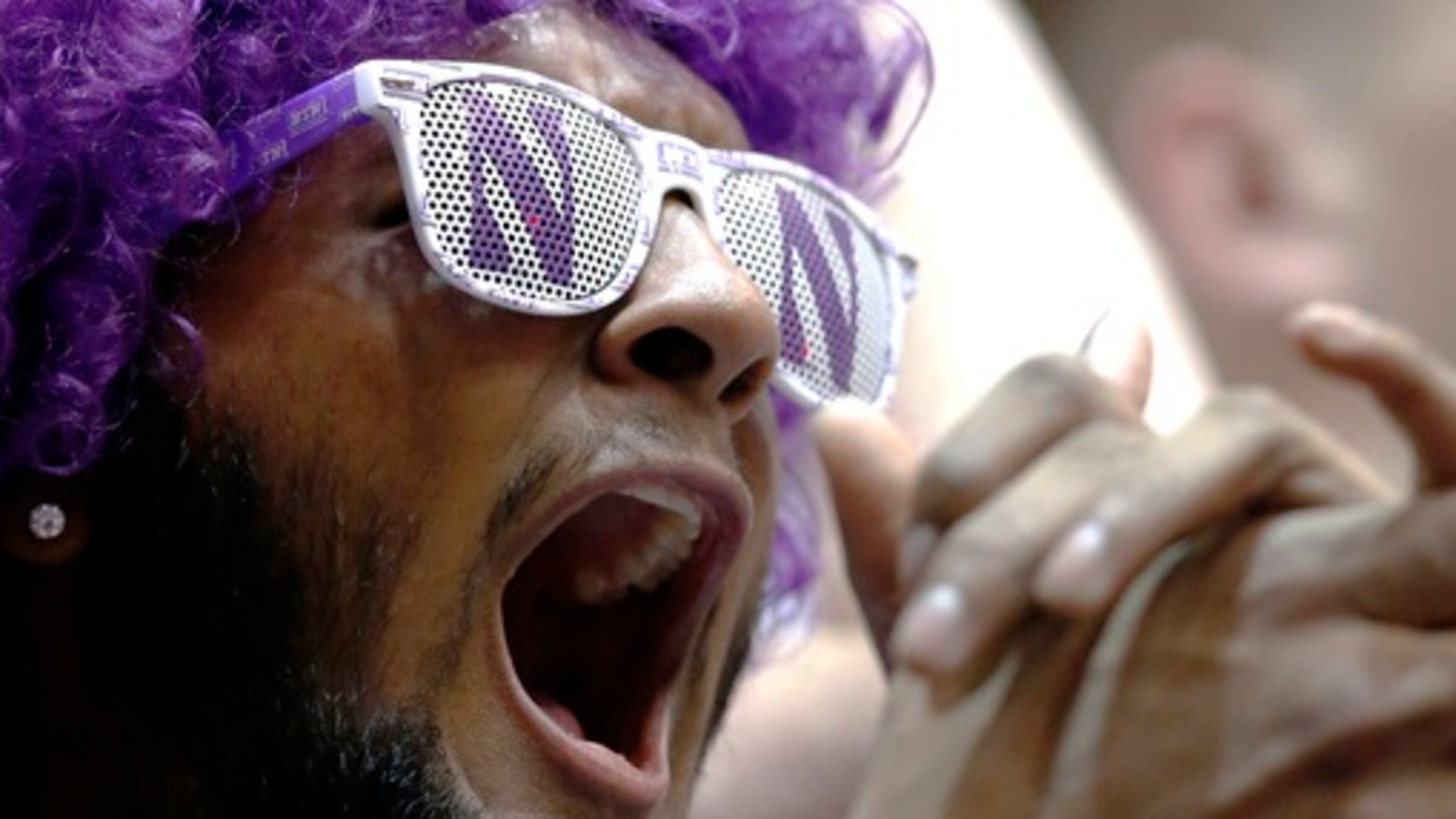A Northwestern fan cheers for his team before an NCAA college basketball game between Purdue and Northwestern Sunday, March 5, 2017, in Evanston, Ill. (AP Photo/Nam Y. Huh)