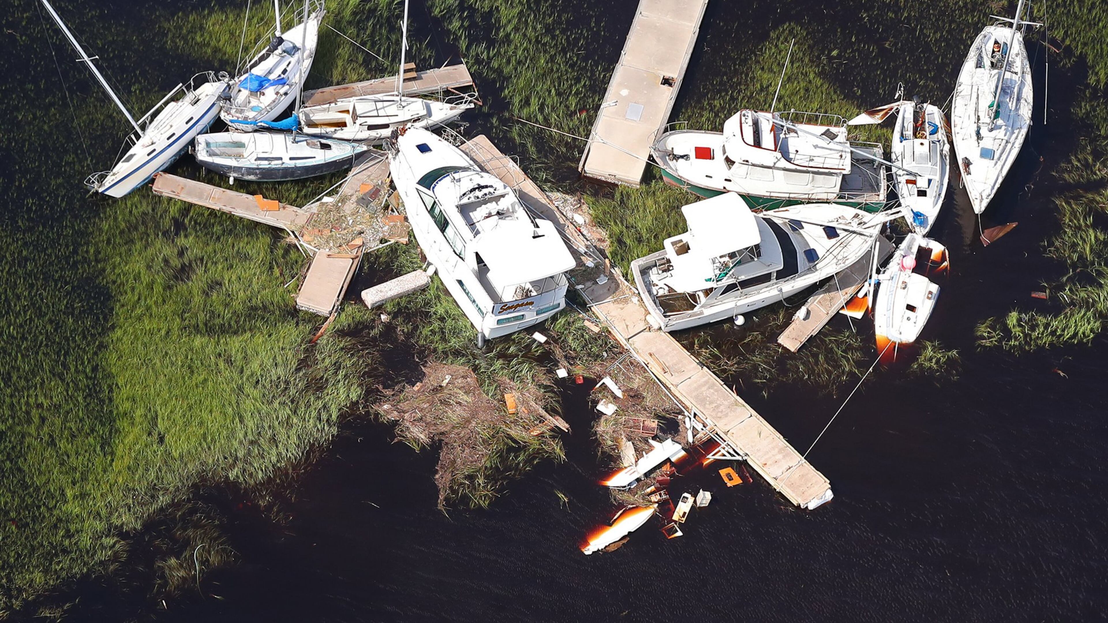 Boats and sections of dock are scattered in the marsh, some sitting on the bottom, after Hurricane Irma in 2017 in St. Marys. Previous docks were damaged by 2016's Hurricane Matthew and 2017's Hurricane Irma, limiting the number of vessels that could tie up. Public docking is now allowed on the island's Plum Orchard, Dungeness and Sea Camp docks. (Curtis Compton/ccompton@ajc.com)