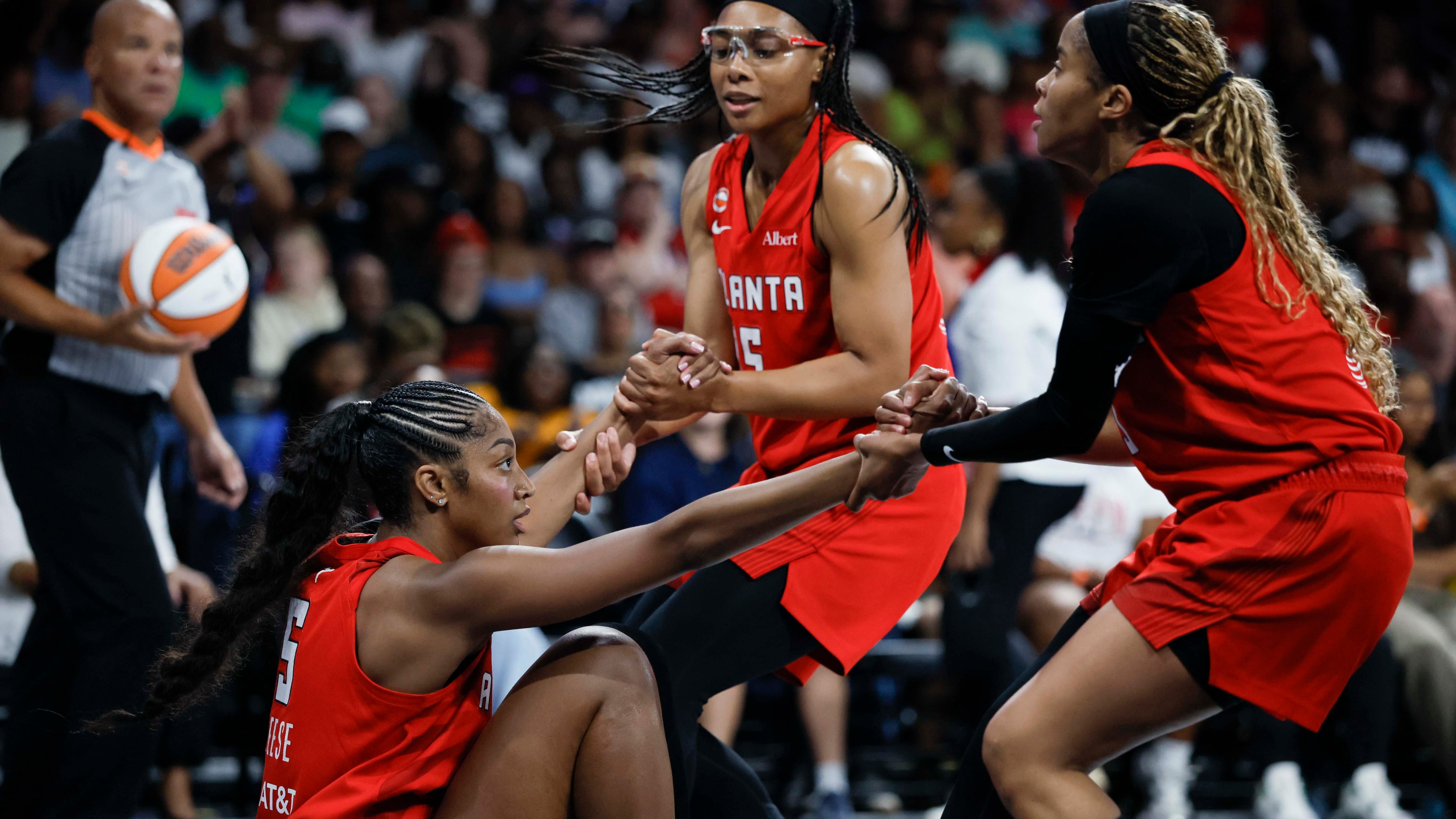 Dream guards Allisha Gray (center) and Jordin Canada help forward Angel Reese up during their game against the Minnesota Lynx at Gateway Center Arena on Sunday, Aug. 30, 2026, in Atlanta. Reese says she and her team are “going to go all the way.” (Miguel Martinez/AJC)