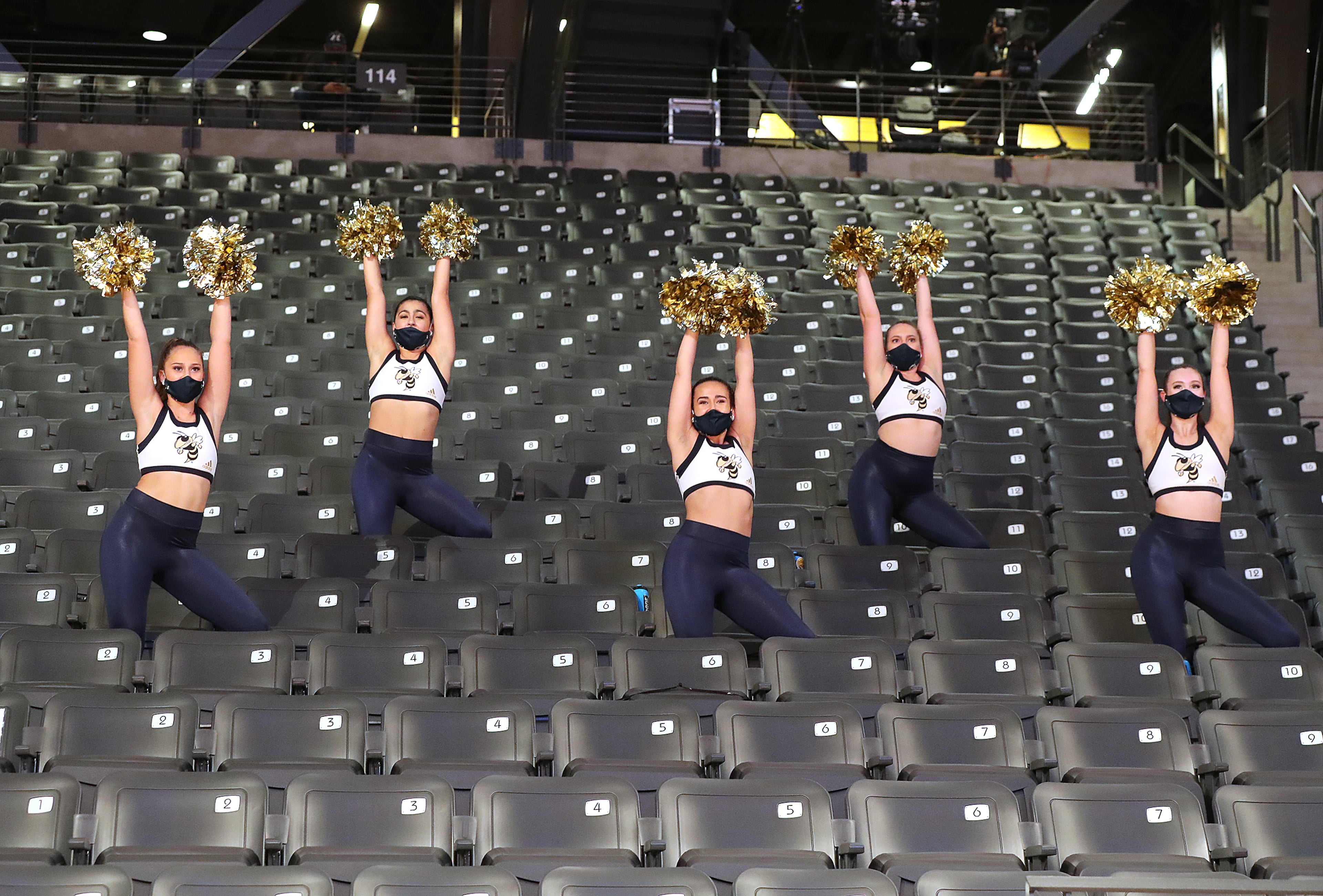 Georgia Tech cheerleaders and mask up in mostly empty stands during the season opener against Georgia State in a NCAA college basketball game in Atlanta on Wednesday, Nov 25, 2020, in Atlanta. “Curtis Compton / Curtis.Compton@ajc.com”