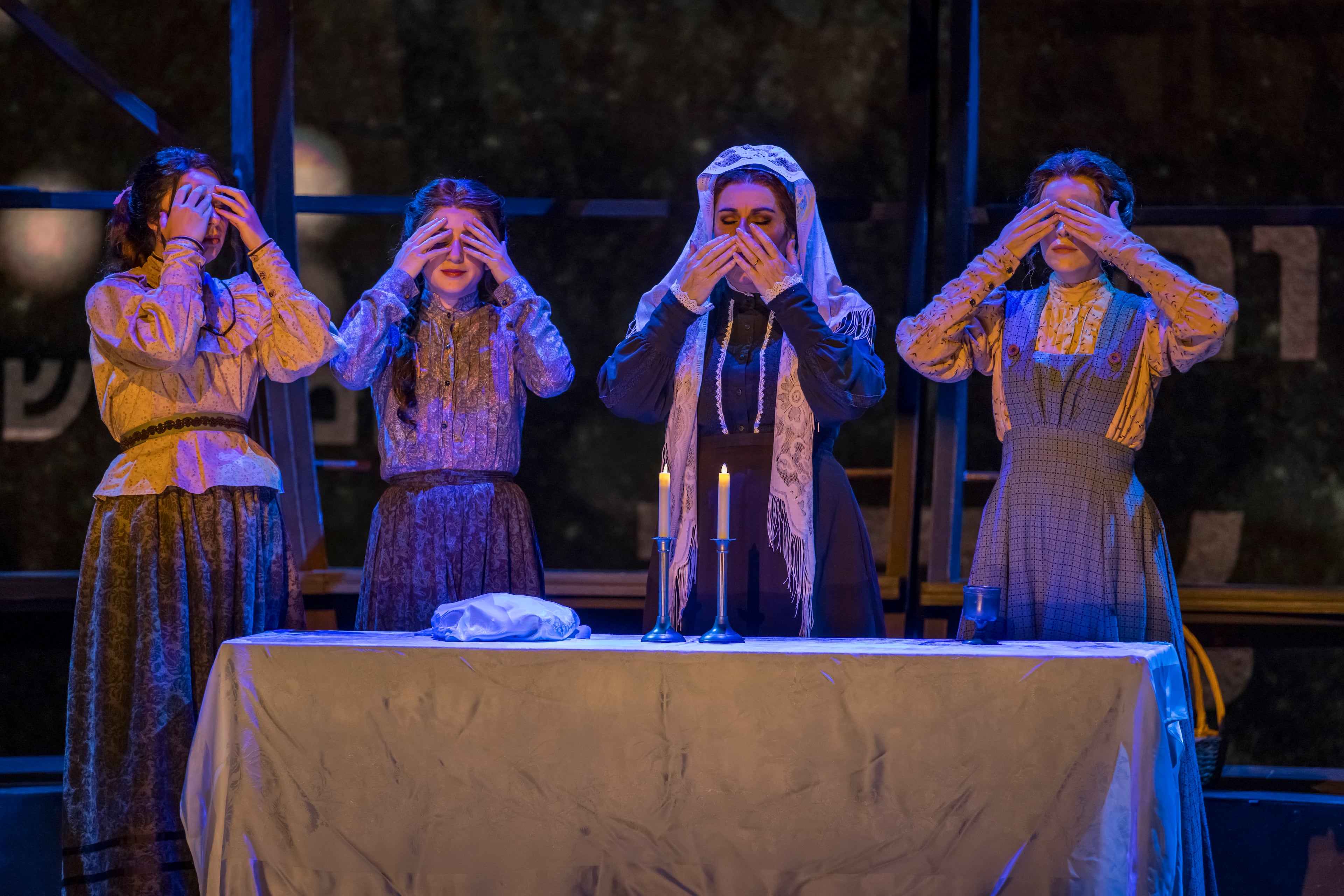 Mia Pinero (from left), Maya Jacobson, Debbie Gravitte and Amanda Fallon Smith observe the Sabbath in "Fiddler on the Roof," customarily covering their eyes during prayer. (Photo credit: Raftermen)