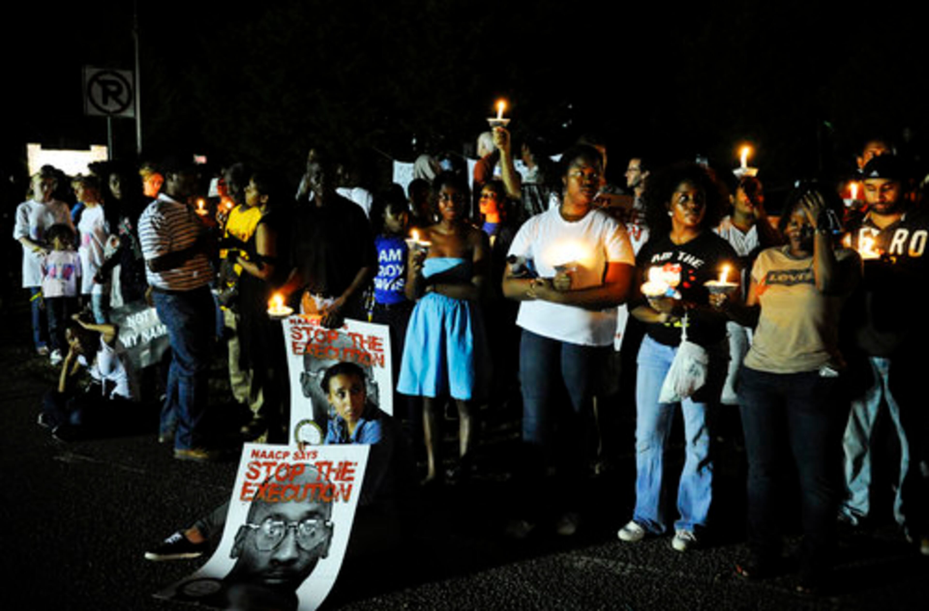 Demonstrators, protesting the scheduled execution of Troy Davis, hold vigil across the road from a prison in Jackson, Ga., Sept. 21, 2011.