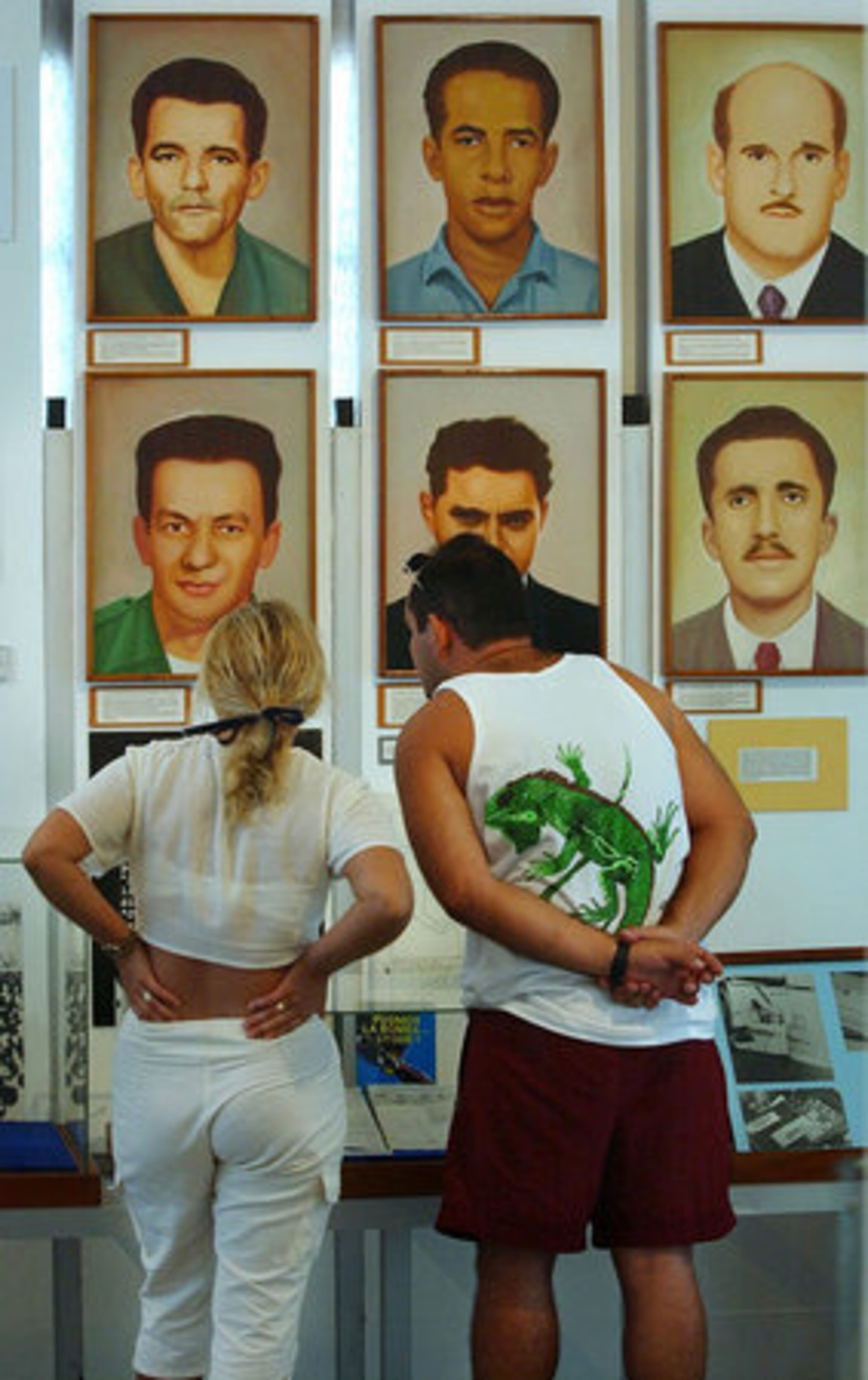 Mexican tourists Domingo Gonzalez and wife Marianna look at portraits of Cuban patriots at the Ministry of the Interior Museum in Miramar, a suburb of Havana. The island is a popular tourist resort for those in the Caribbean and Europe.