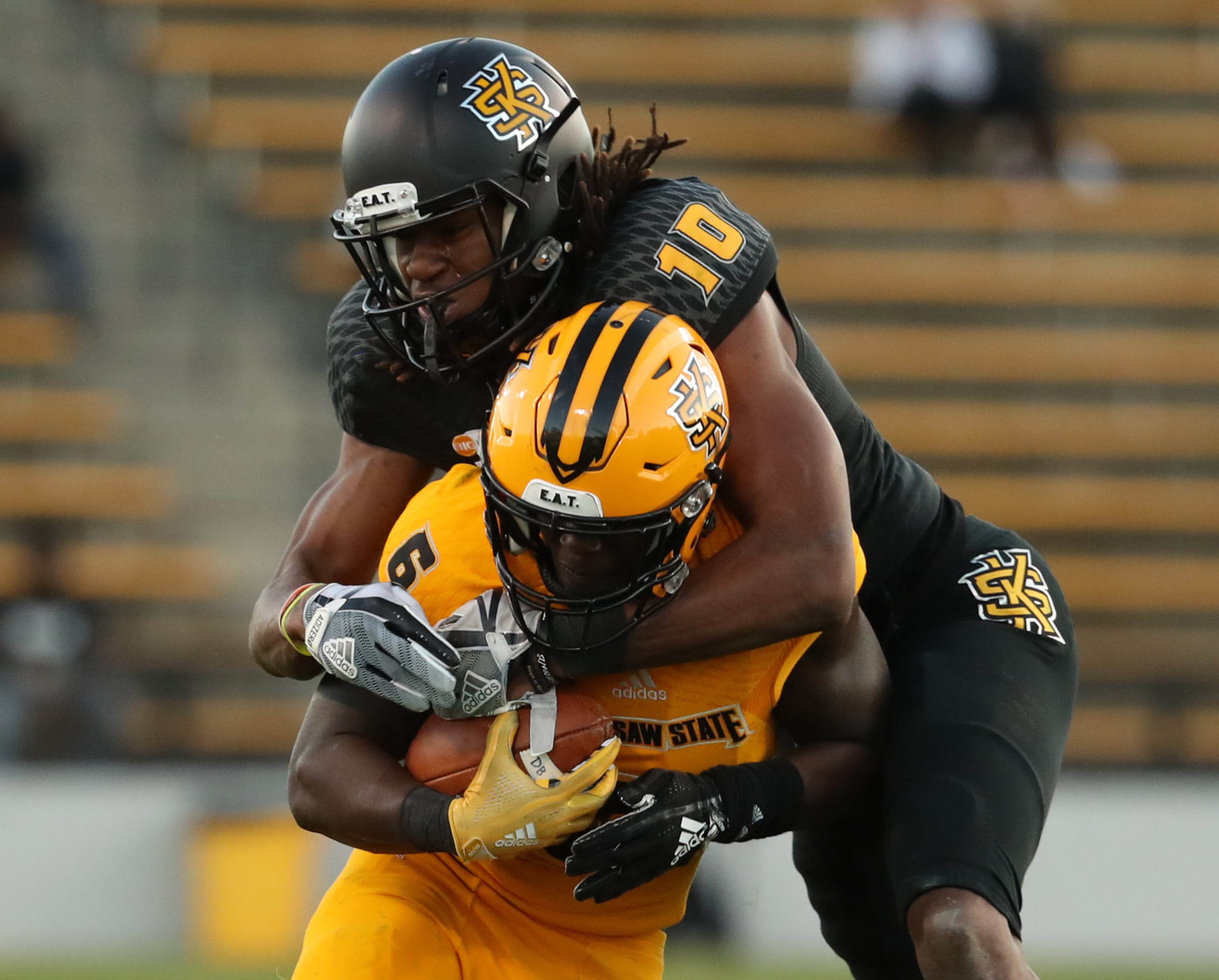 March 22, 2019 - Kennesaw, Ga: Kennesaw State Owls running back TJ Reed (6) is tackled by defensive back Quae Drake (10) during the KSU spring football game at Fifth Third Bank Stadium Friday, March 22, 2019 in Kennesaw, Ga.. (JASON GETZ/SPECIAL TO THE AJC)