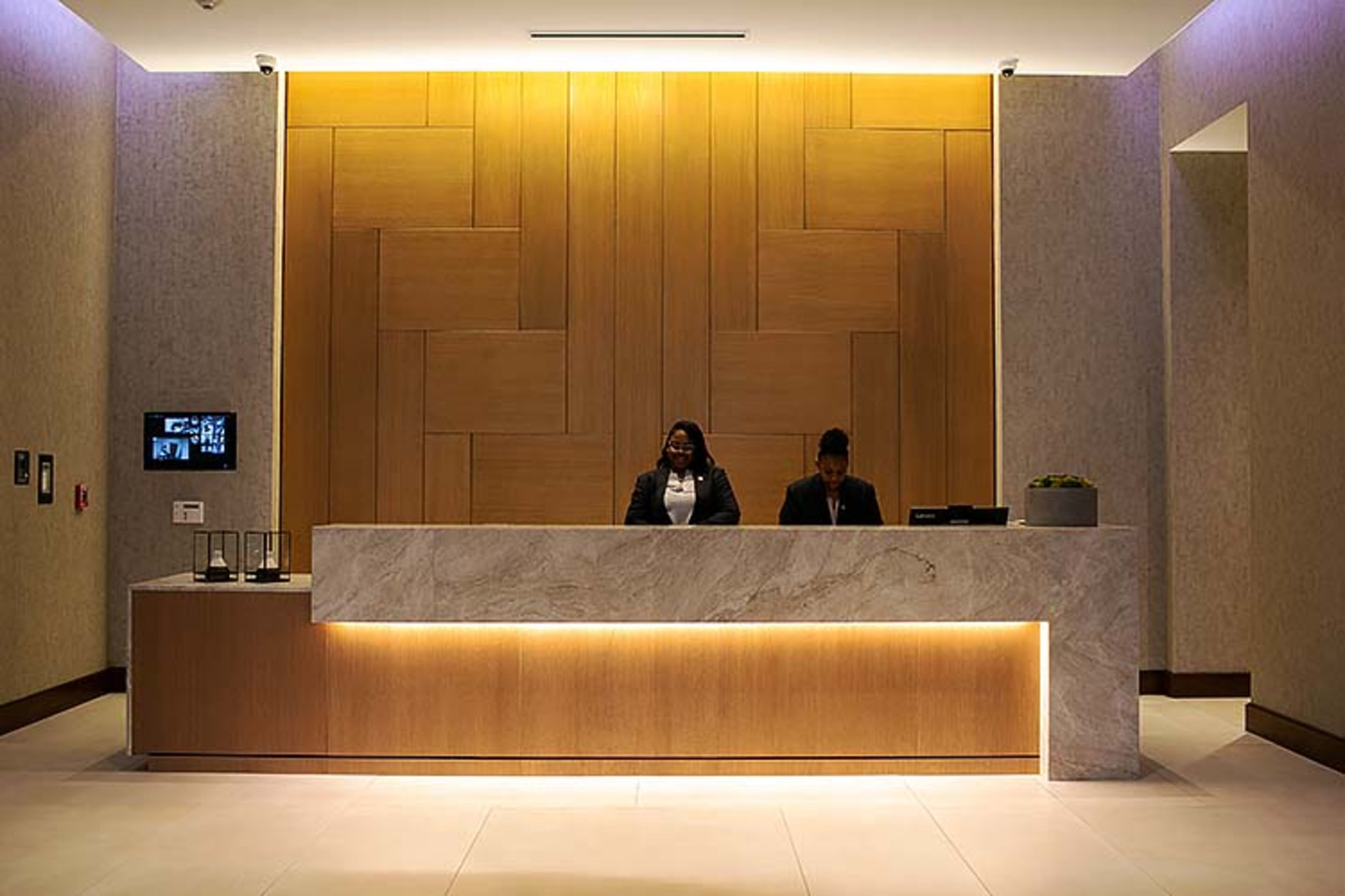 Alexis Griggs and Ayana Kendrick wait to check in guests at the AC Hotel at Gateway Center in College Park, Georgia, on Thursday, February 20, 2020. The new hotel is one of the many economic development projects of AtlantaâÃôs Southside. (Photo/Rebecca Wright for the AJC)
