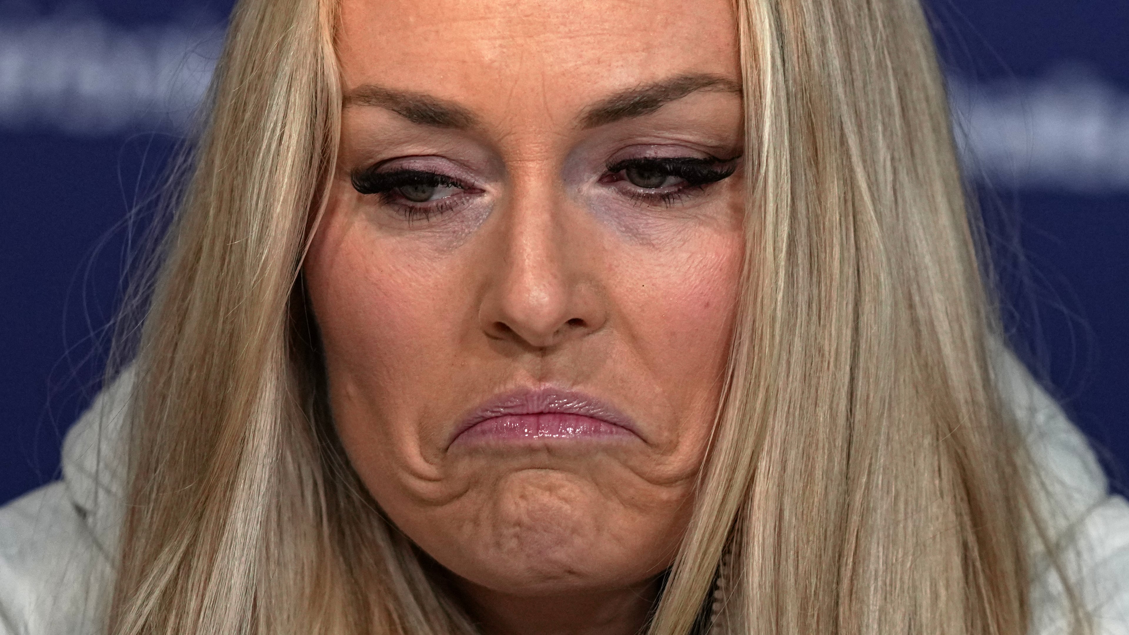United States' Lindsey Vonn grimaces during a press conference by the U.S. ski team at the 2026 Winter Olympics, in Cortina d'Ampezzo, Italy, Tuesday, Feb. 3, 2026. (AP Photo/Fatima Shbair)