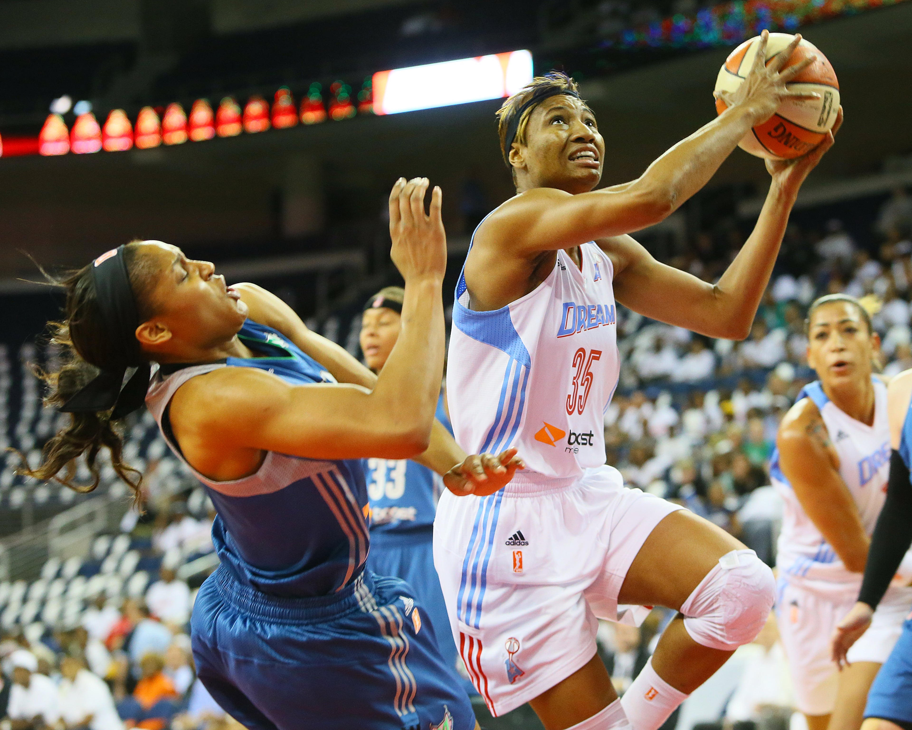 Dream forward Angel McCoughtry battles under the basket past Lynx forward Maya Moore during the first half of their WNBA Finals basketball game 3 on Thursday, Oct. 10, 2013, in Duluth.