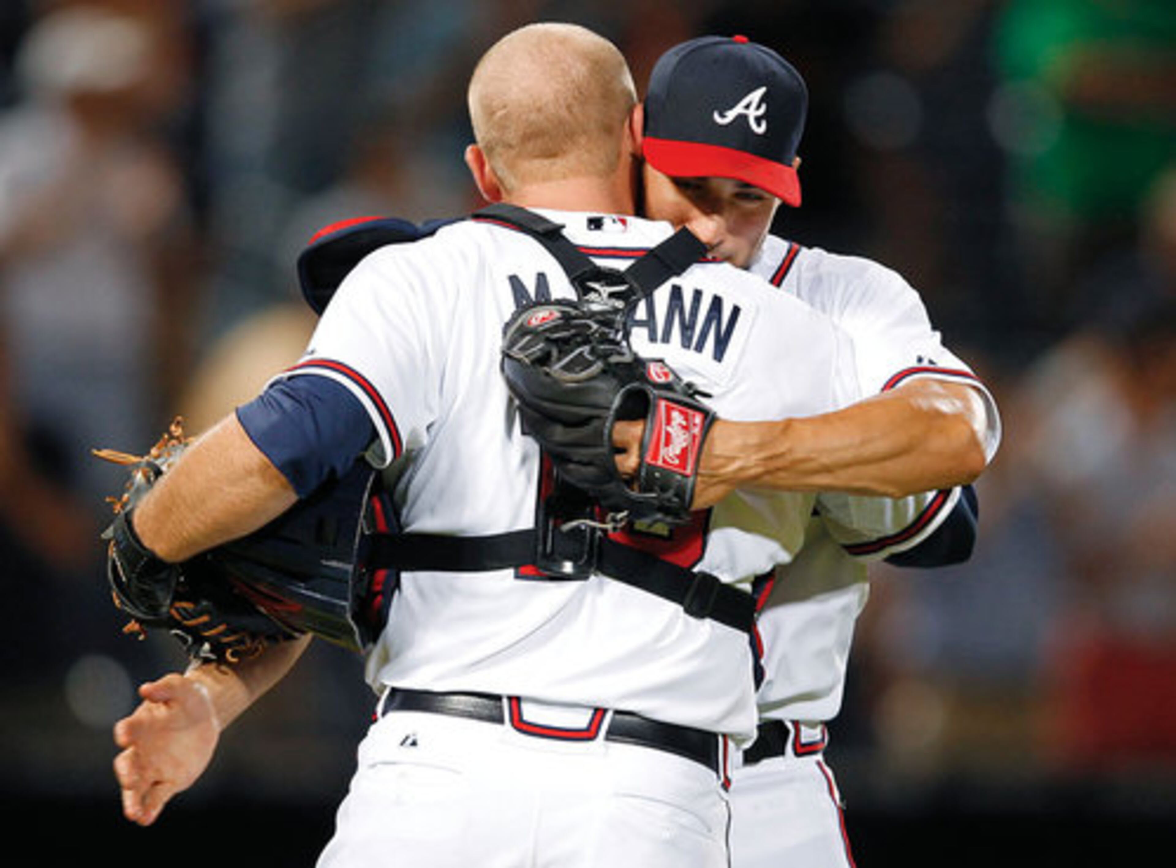 Brandon Beachy (37) embraces catcher Brian McCann after the Braves defeated the Miami Marlins 7-0 on May 17, 2012.