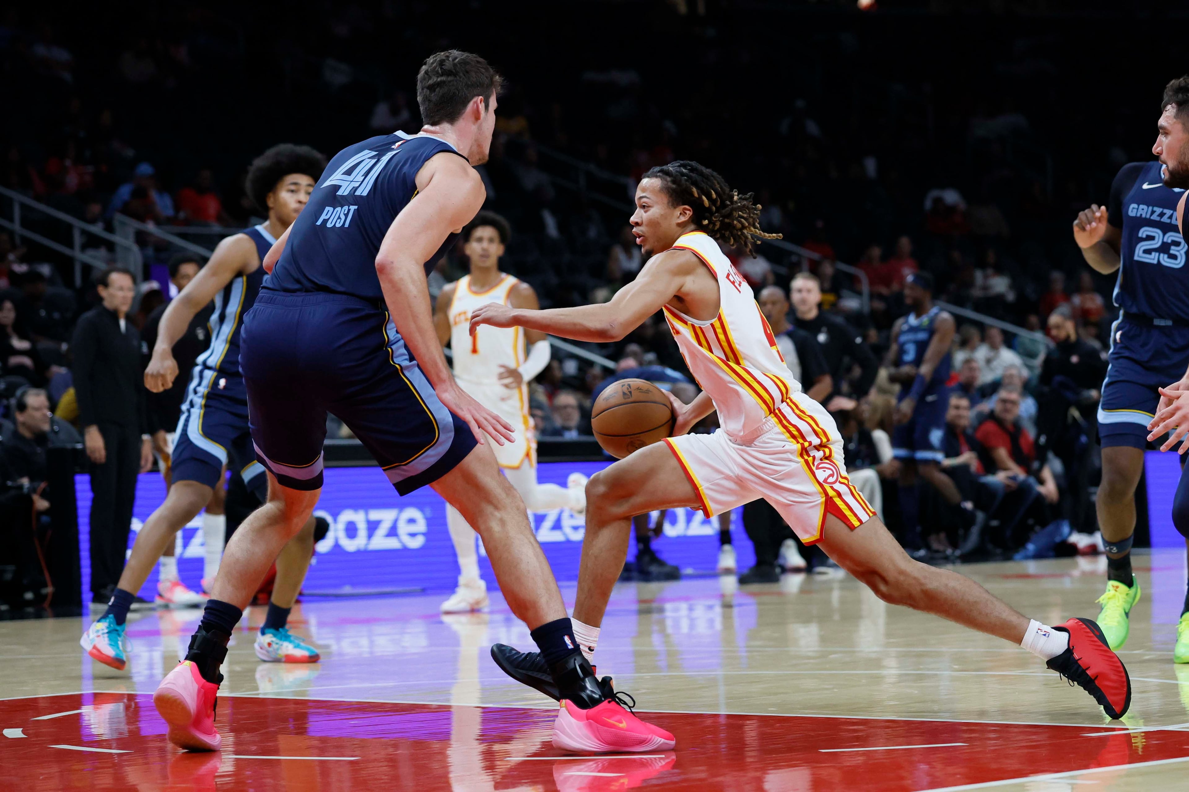 Atlanta Hawks guard Kingston Flemings (right) dribbles against Memphis Grizzlies center Quinten Post (left) in the first half of a preseason NBA game at State Farm Arena in Atlanta on Monday, Oct. 5, 2026. (Miguel Martinez/AJC)