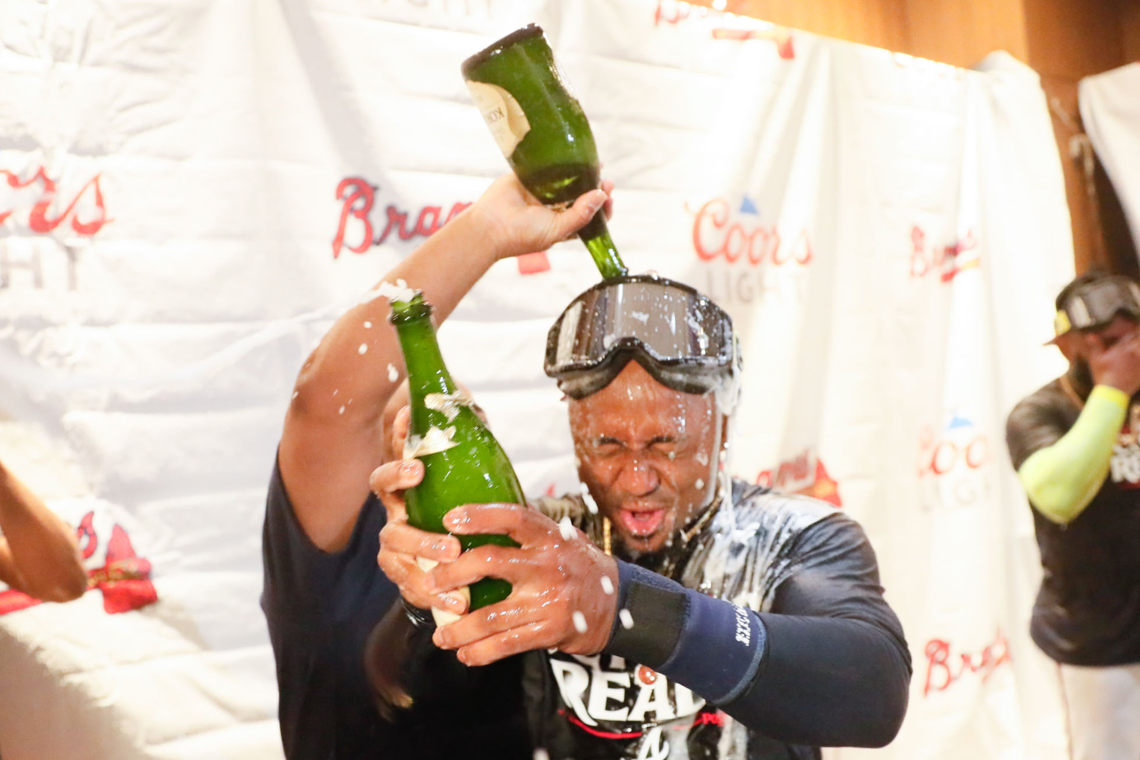 Ozzie Albies gets a shower with champagne after their 3-0 win over the Mets in the second game of Monday’s doubleheader.
(Miguel Martinez/ AJC)