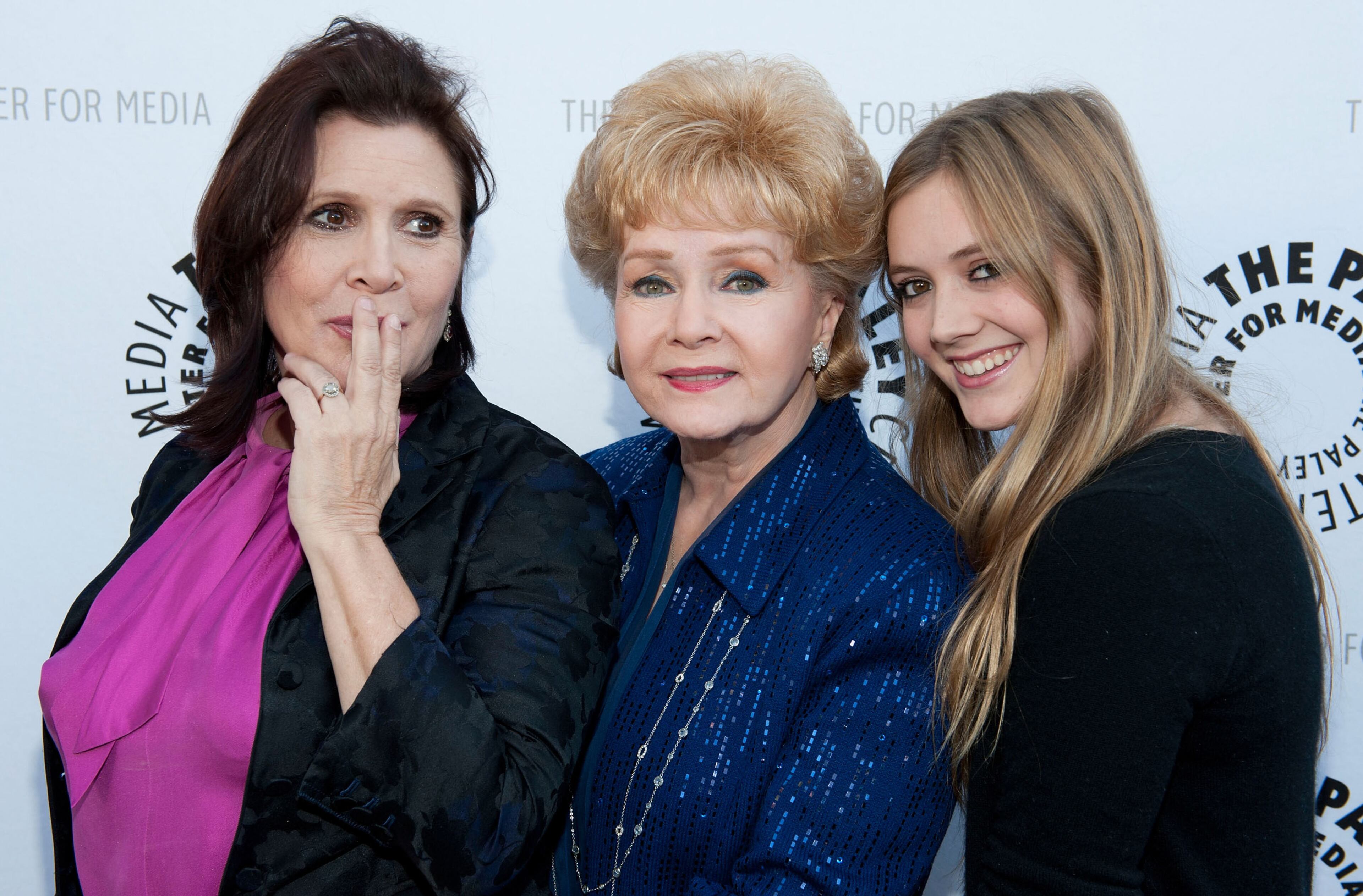 Actress and writer Carrie Fisher; her mother, Debbie Reynolds; and daughter Billie Lourd arrive at Debbie Reynolds' Hollywood Memorabilia Exhibit Reception on June 7, 2011, in Beverly Hills, California. (Photo by Amanda Edwards/Getty Images)