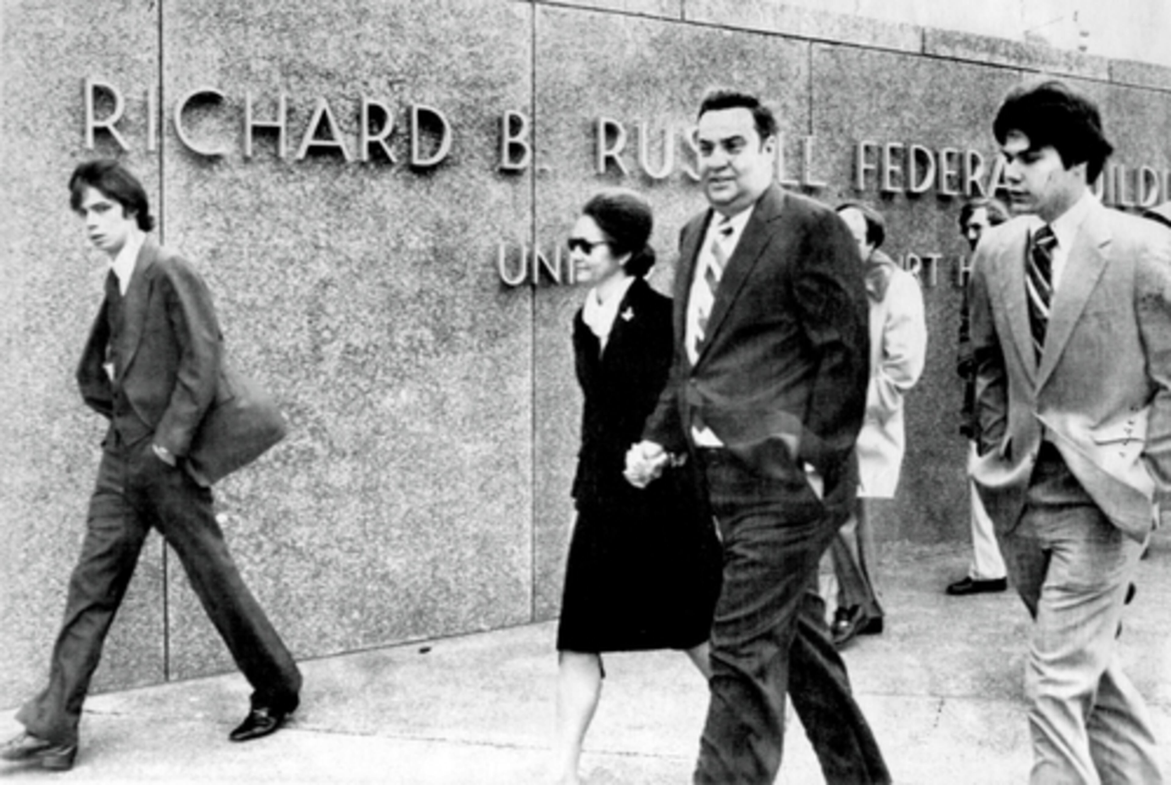 Questions soon surfaced about improper loans made while Lance headed the Calhoun bank, and when he learned the bank was about to write off the loans and drop the value of his holdings, he offered to resign to reorganize his affairs. Here, Lance, along with his son Tram (left), wife LaBelle, and other son Beverly (right) walk into the Richard B. Russell Federal building.