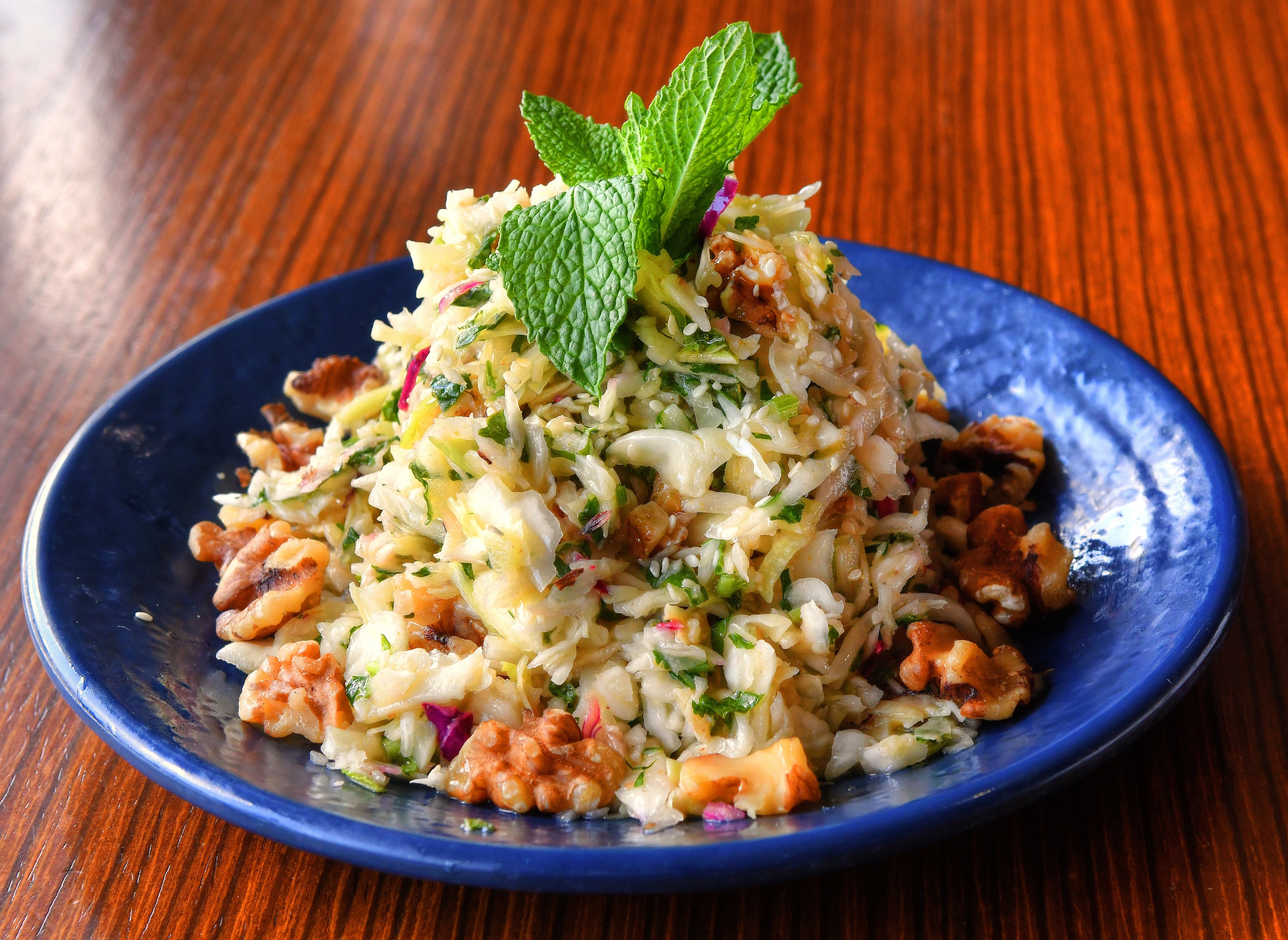 Chef Faik Usman's Salad of Cabbage, Mint and Walnuts, from Faik Usman, the chef-owner of Cafe Raik in Duluth, is a delicious way to use fall cabbage. Lemon and fresh mint make it fresh and clean tasting; chopped walnuts add a bit of crunch. (Styling by chef Faik Usman / Chris Hunt for the AJC)